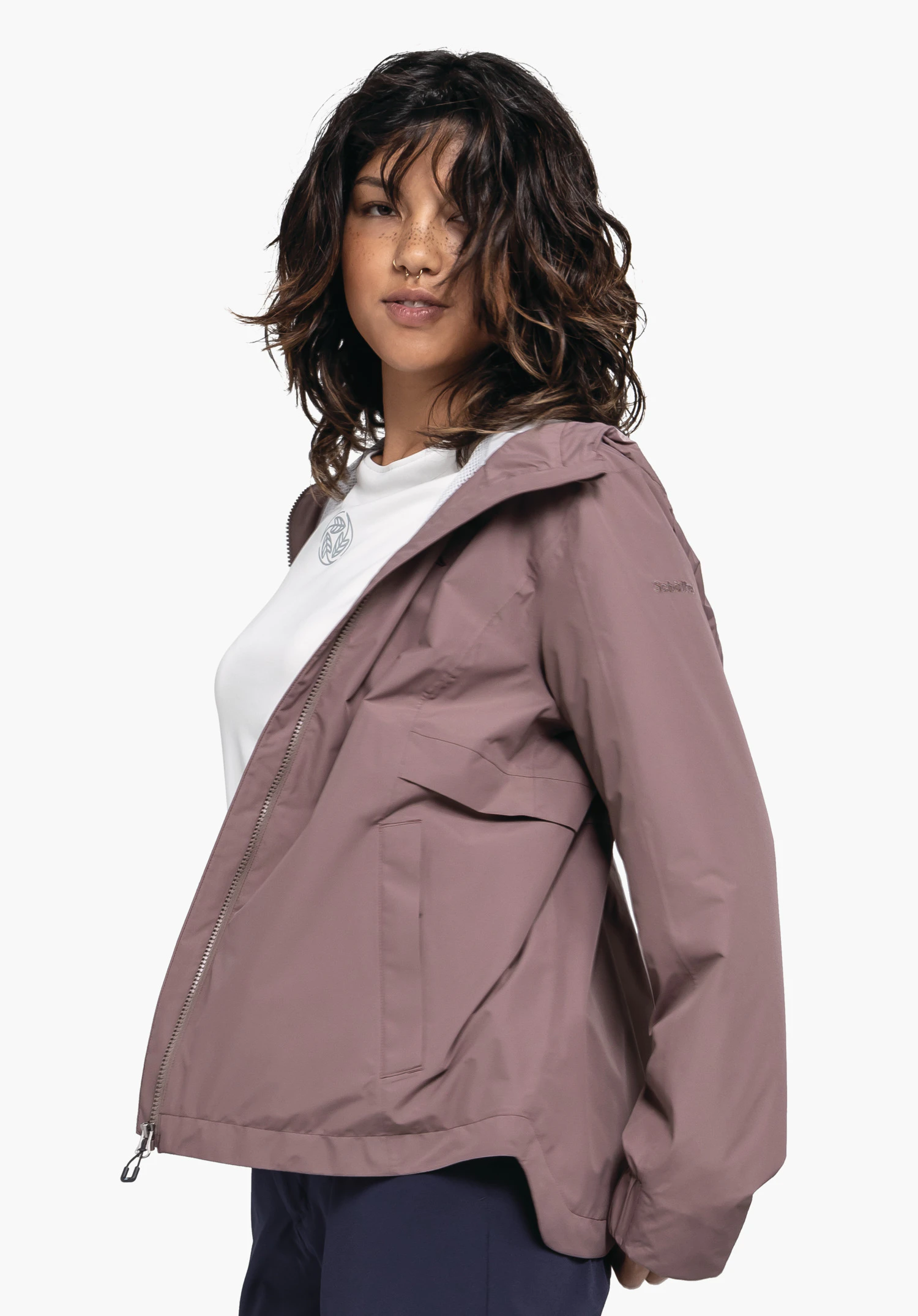 Jacket Style Bohorok WMS in brown, worn by a model in front of a neutral background. The model is standing in a semi-profile pose, showcasing the jacket. The subtle Schöffel logo on the upper arm completes the premium look.