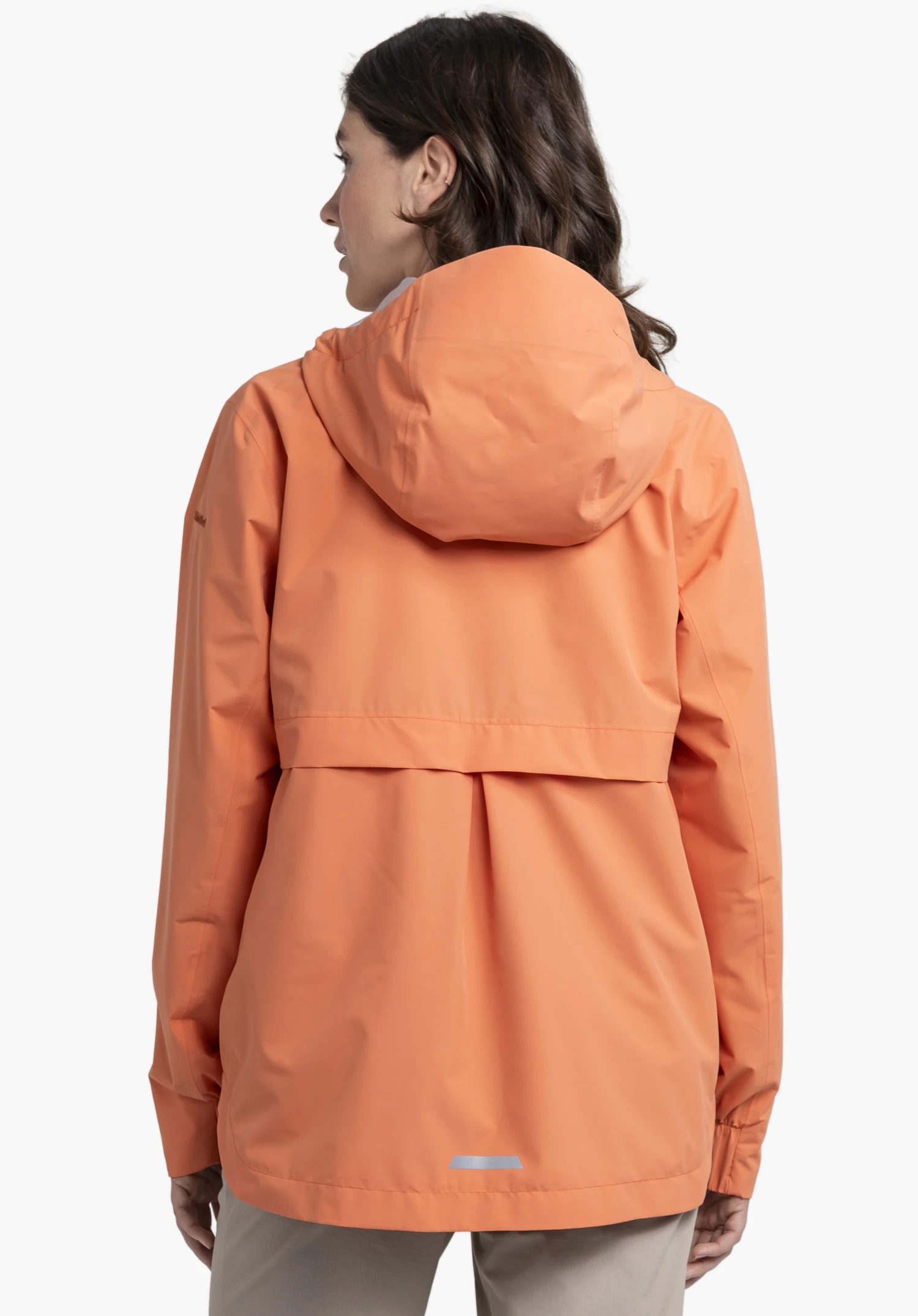 Jacket Style Bohorok WMS in the colour orange. A model presents the jacket from the back. Visible are the hood, a back yoke, the Schöffel logo on the left sleeve and a reflective detail at the bottom hem. The model is standing against a neutral background.