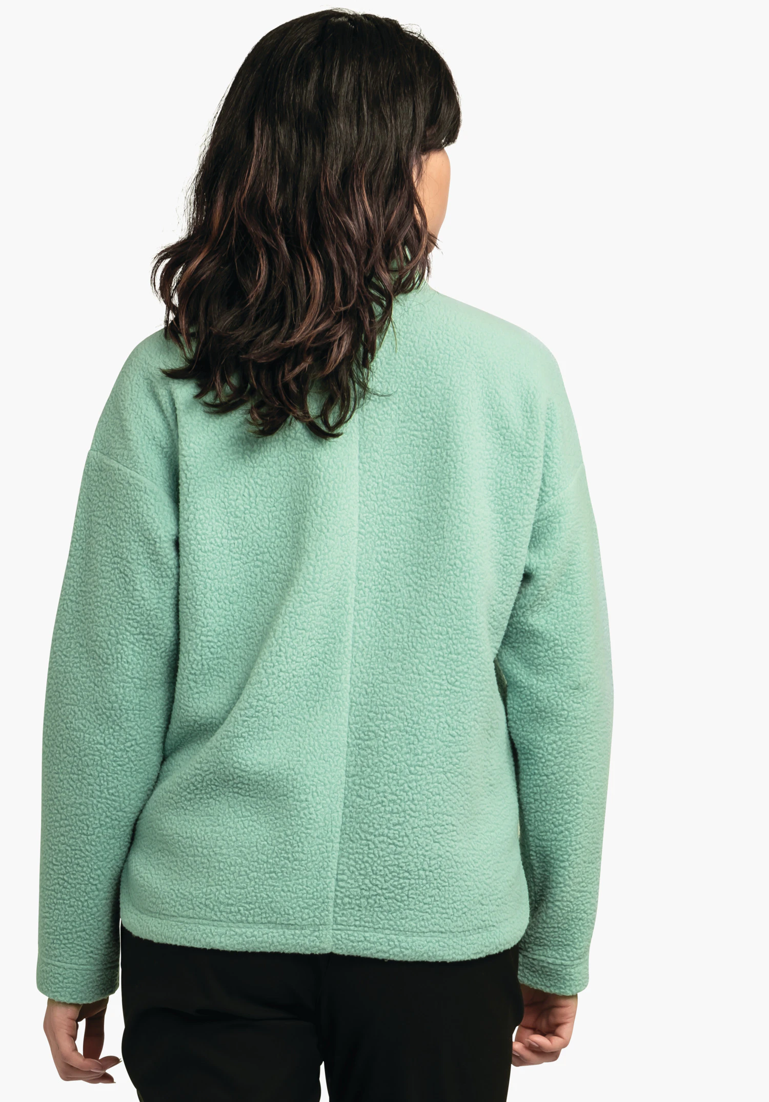 CIRC Fleece Jk Style Purga WMS veste polaire vert clair, portée de dos; personne debout devant un fond clair neutre, pantalon noir.