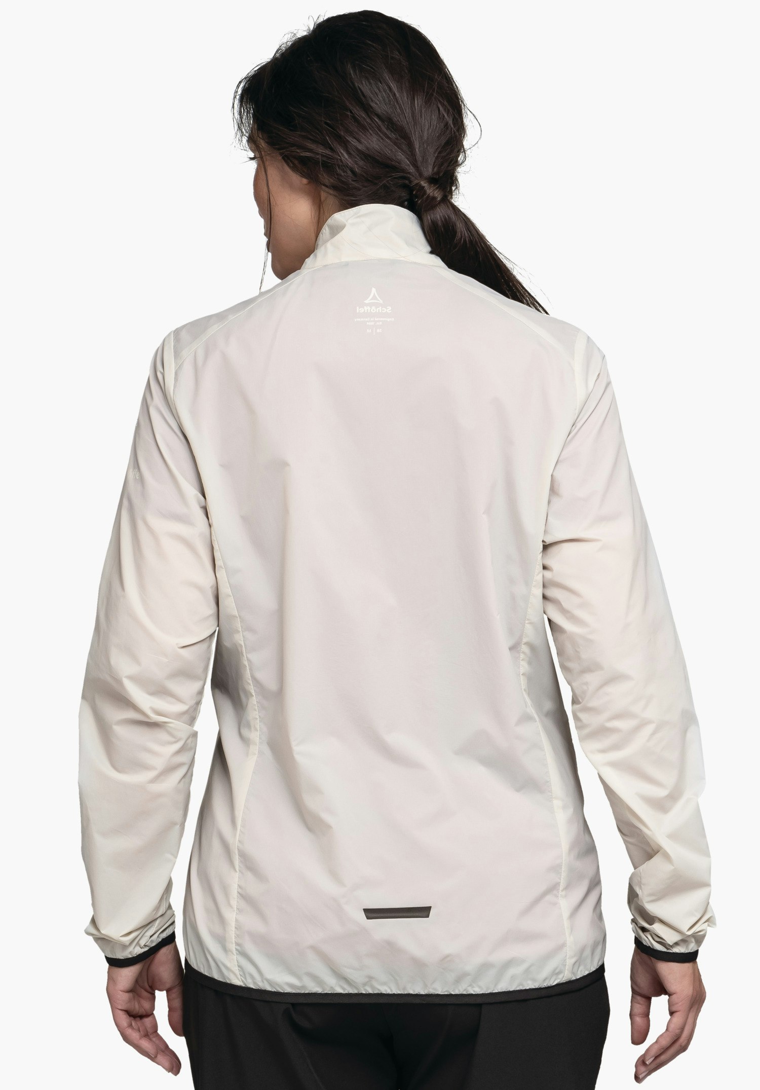 Jacket Style Cannobio WMS off-white rain jacket worn in rear view; model stands against a white background; Schöffel logo and “Schöffel” lettering centred at the upper back; black reflective strip at the lower back.
