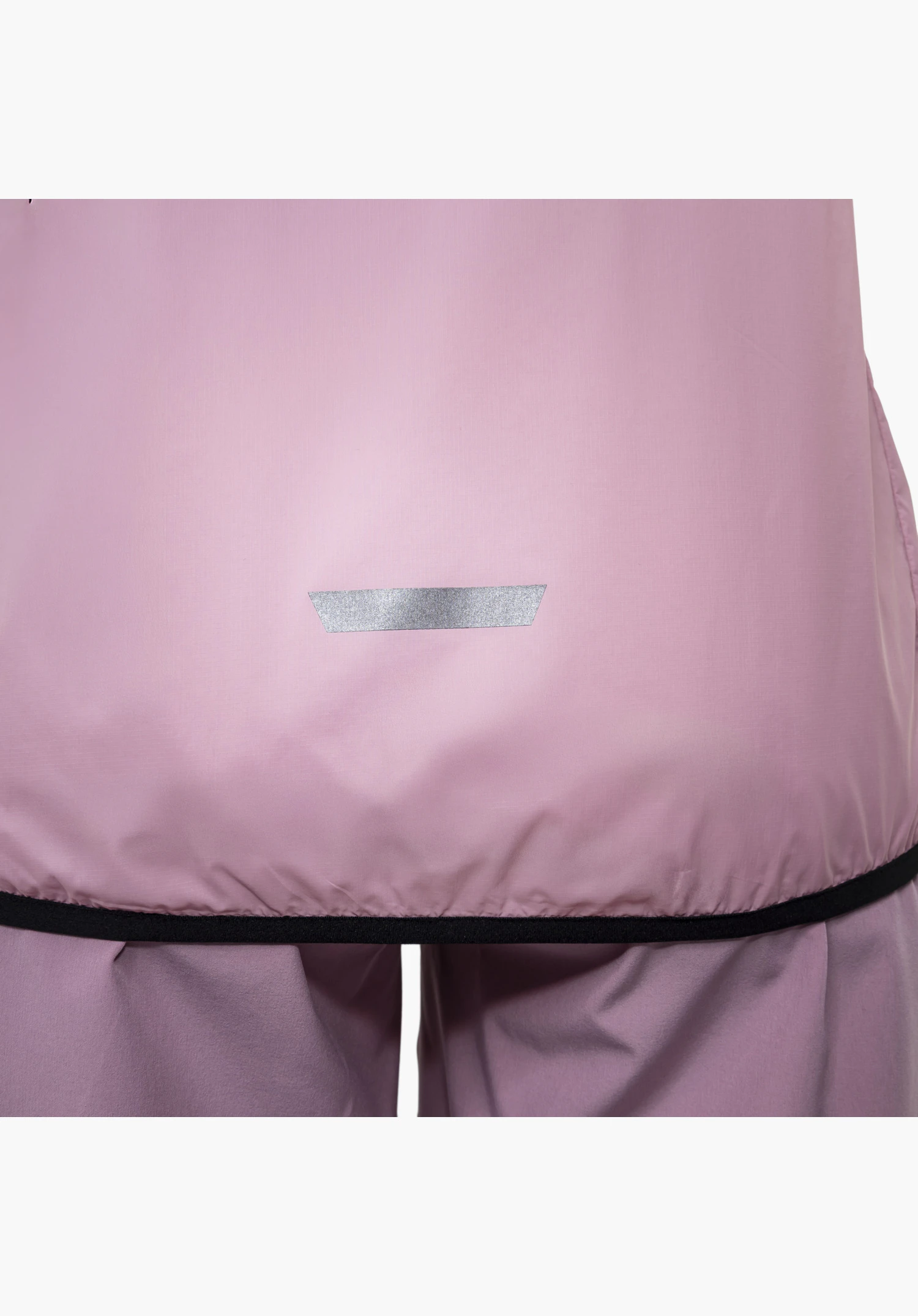 Vest Style Cannobio WMS features a narrow reflective element and the black elasticated hem on the smooth pink fabric at the lower back, close-up against a white/neutral background.