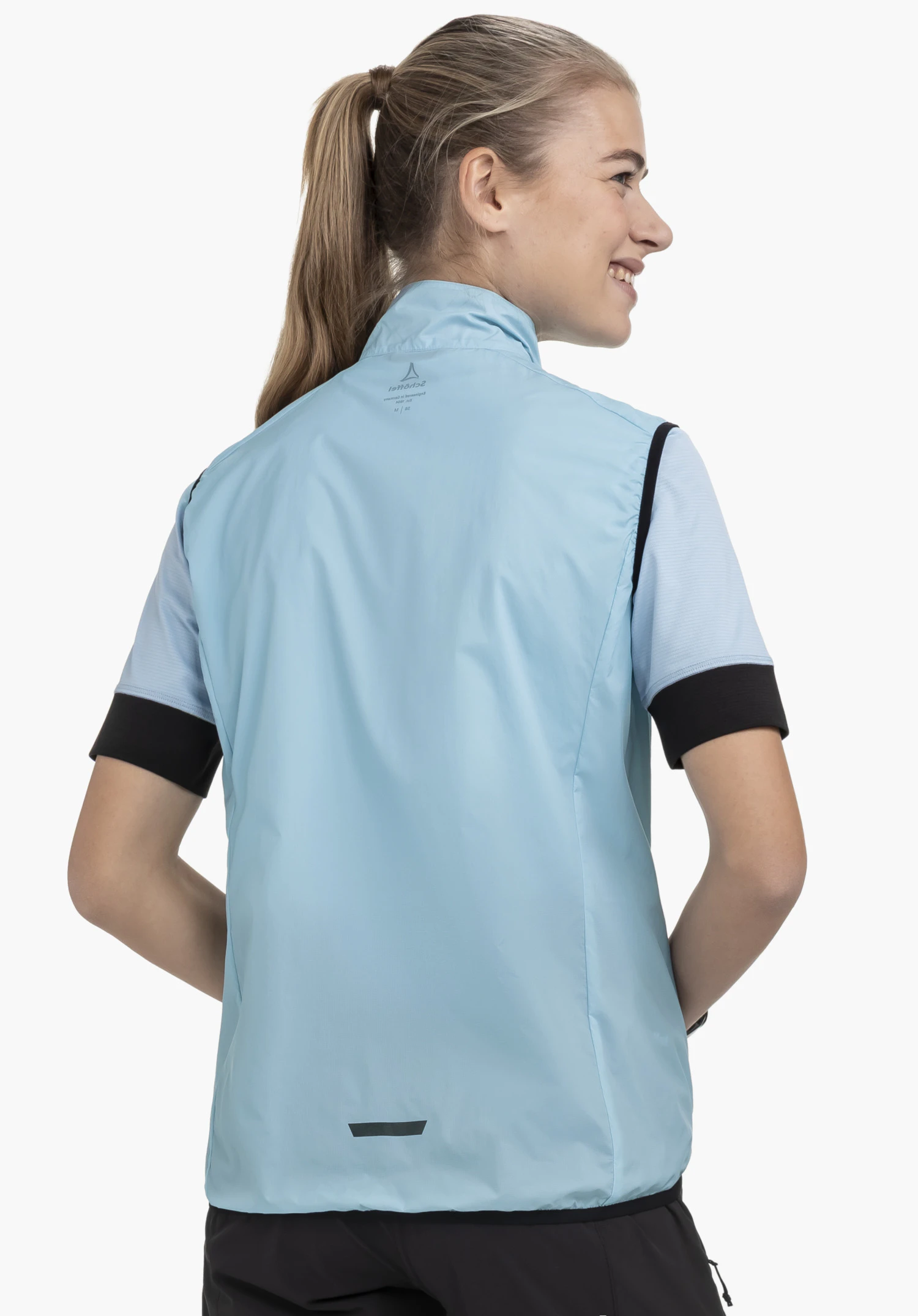 Vest Style Cannobio WMS in blue, showing a back view on a model against a neutral background, with the Schöffel logo visible at the nape of the neck.