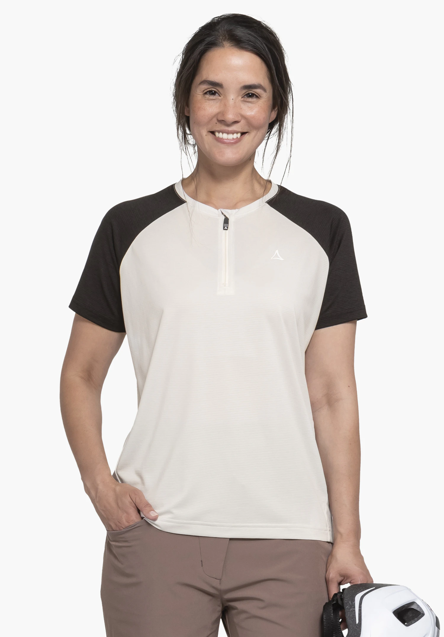 CIRC Shirt Style Wetluga WMS dans le coloris natur. Une femme souriante se tient de face devant un arrière-plan neutre pour présenter le t-shirt. Le modèle se distingue par ses manches raglan et sa courte fermeture éclair, tandis que le logo Schöffel discret sur la poitrine complète le look.