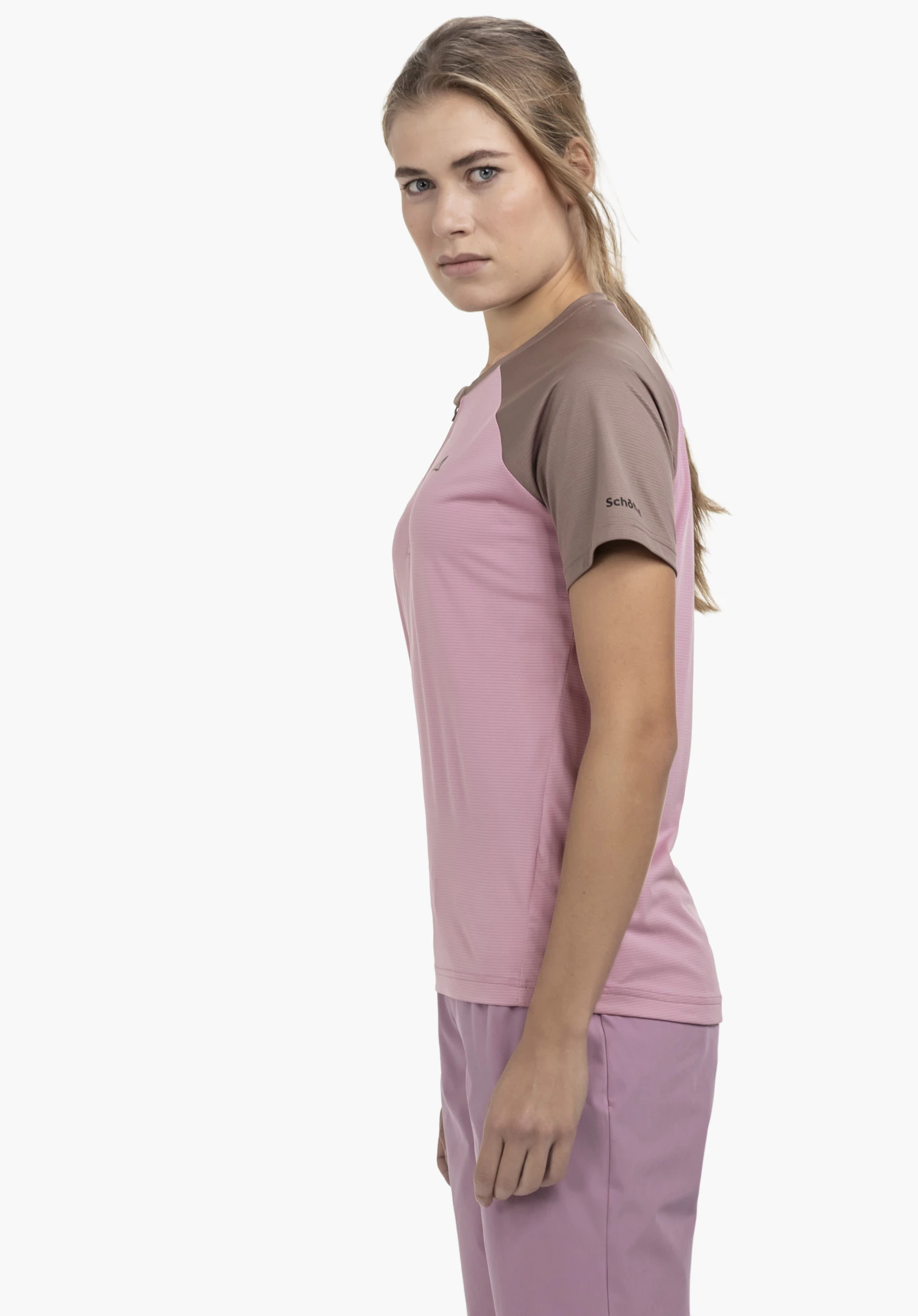 CIRC Shirt Style Wetluga WMS in pink. The model is standing in a side profile view against a neutral background, showcasing the shirt with its distinctive contrasting sleeves. The Schöffel logo is clearly visible on the sleeve.