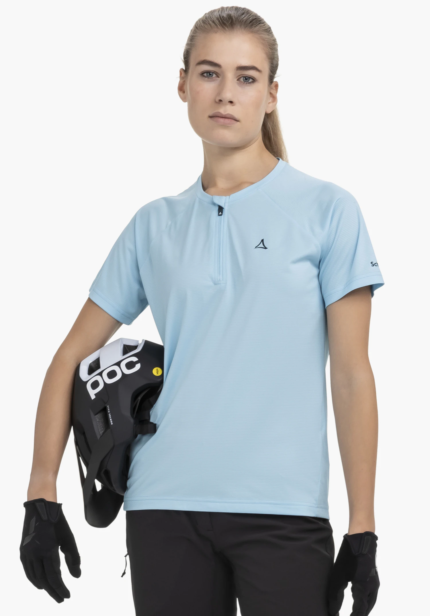 CIRC Shirt Style Wetluga WMS in blue worn by an athlete against a neutral background. The model is standing in a frontal pose holding a helmet, with the subtle Schöffel logo visible on the chest, highlighting the garment's premium athletic look.