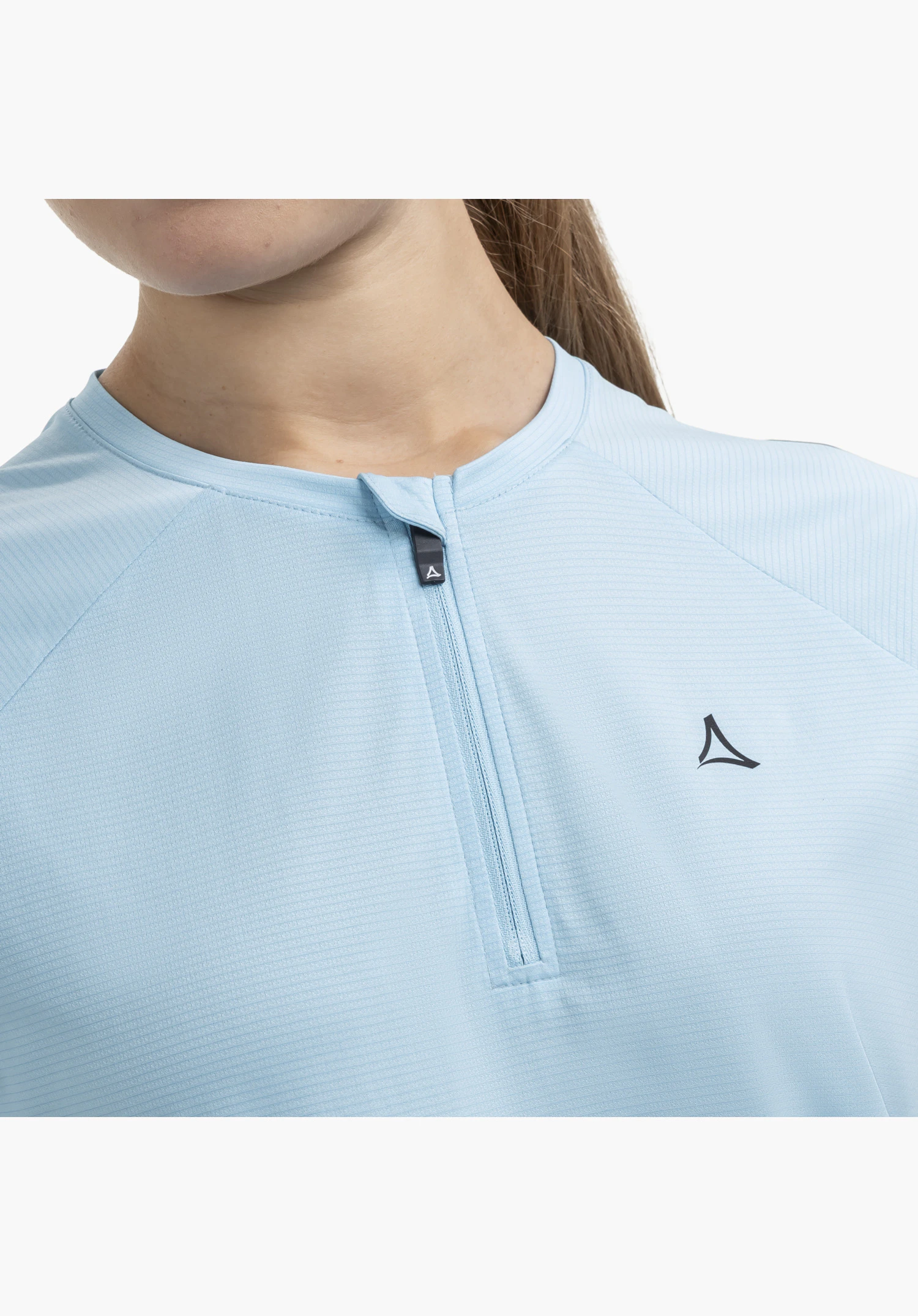 CIRC Shirt Style Wetluga WMS shows the half-zip, the distinctive Schöffel logo on the chest and the finely textured blue fabric surface, close-up against a white background.
