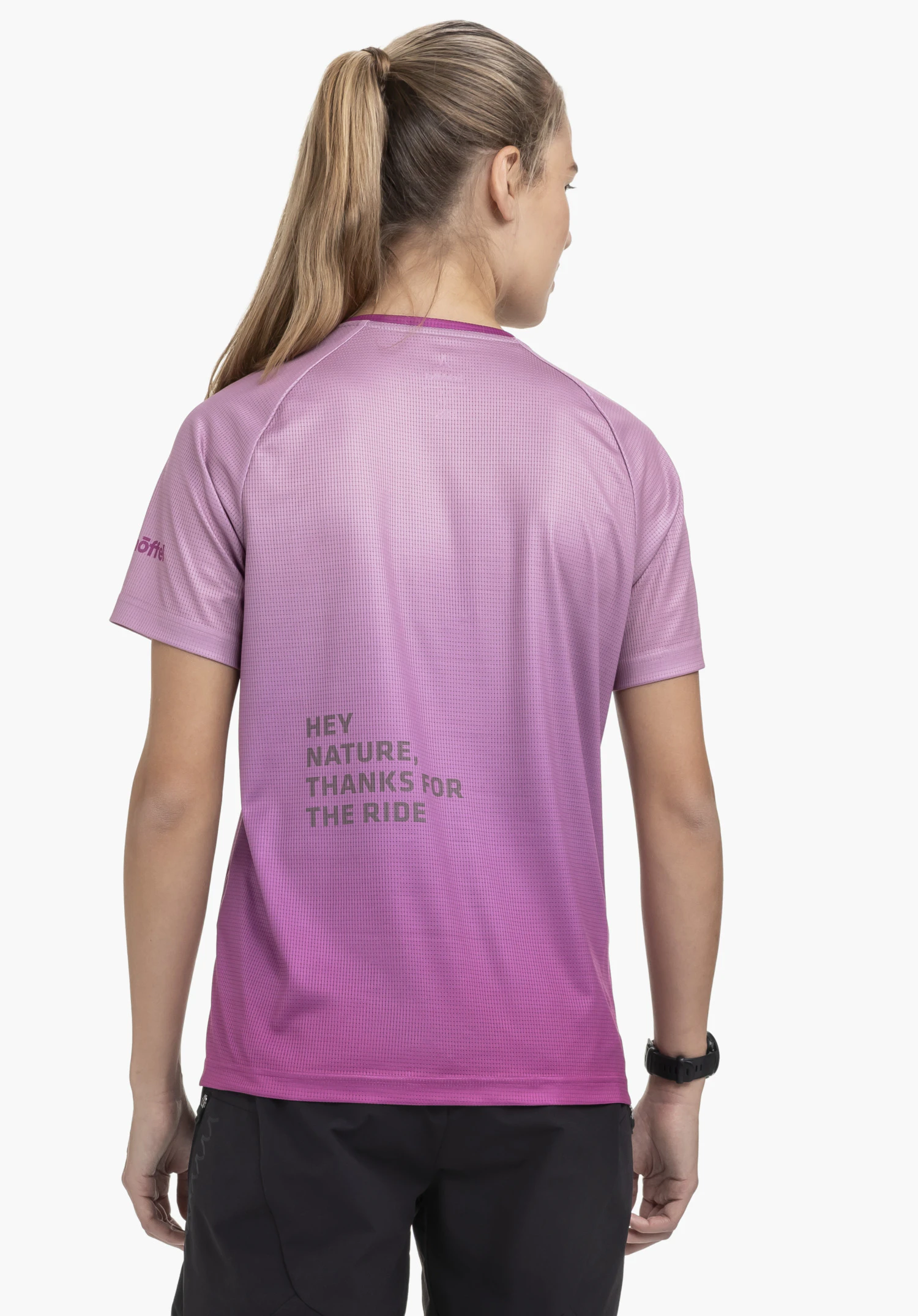 Shirt Style Koitere WMN in pink. The model is shown from the back against a neutral background, highlighting the functional cut and the distinctive lettering detail. The subtle Schöffel logo is visible on the sleeve.