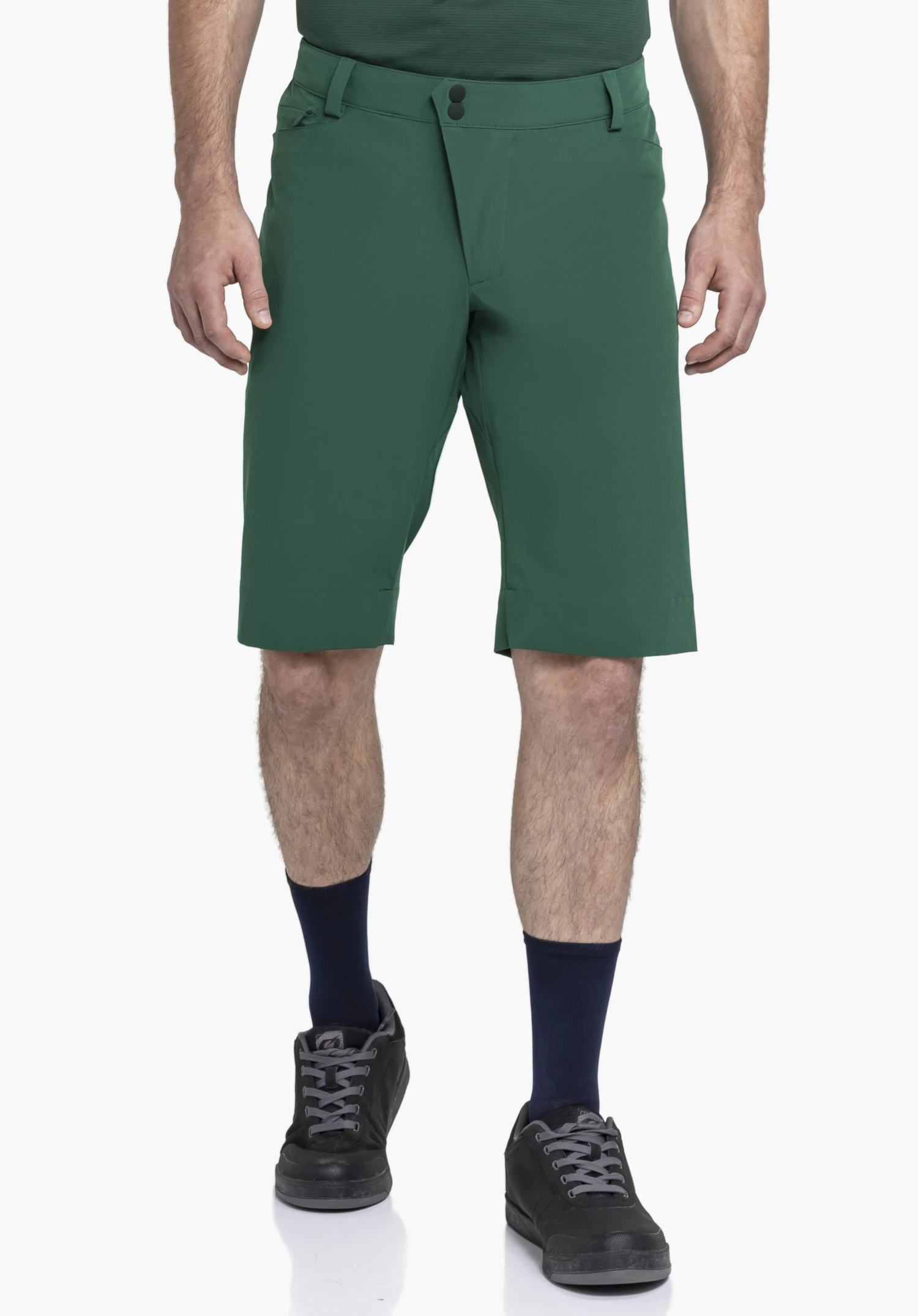 Shorts Style Keitele MNS worn by a model standing facing forward. The green shorts display the front view with a button closure and belt loops against a neutral background.