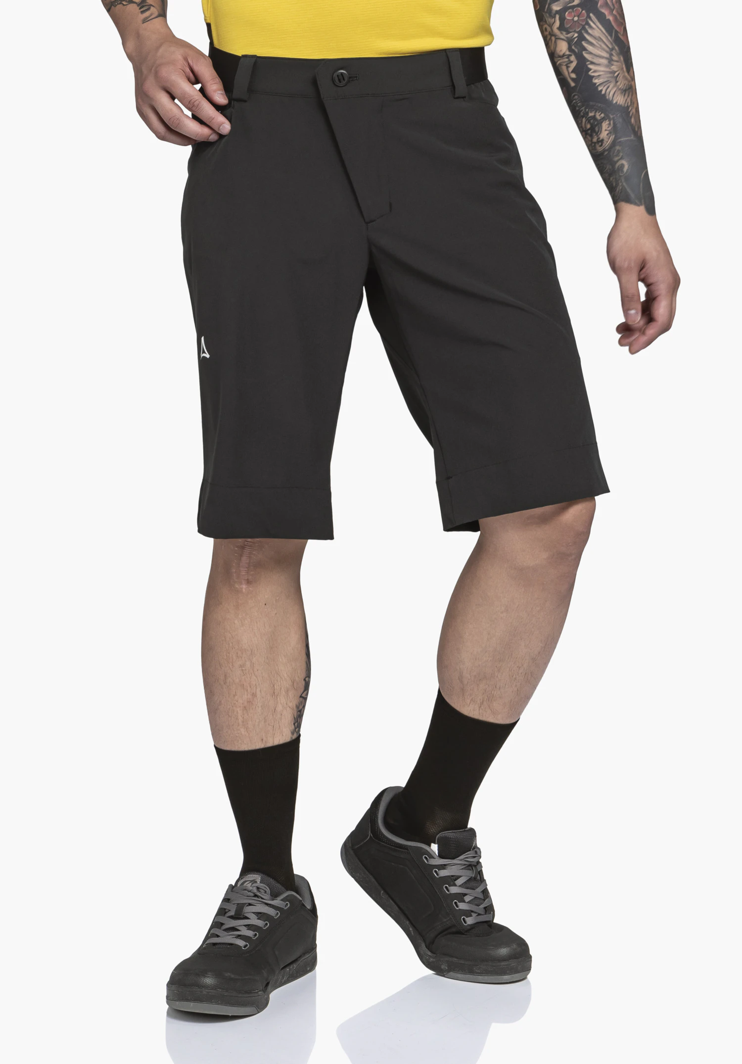 Shorts Style Keitele MNS dark grey shorts worn by a standing man; Schöffel logo visible at the side; black socks and black shoes; white studio background.