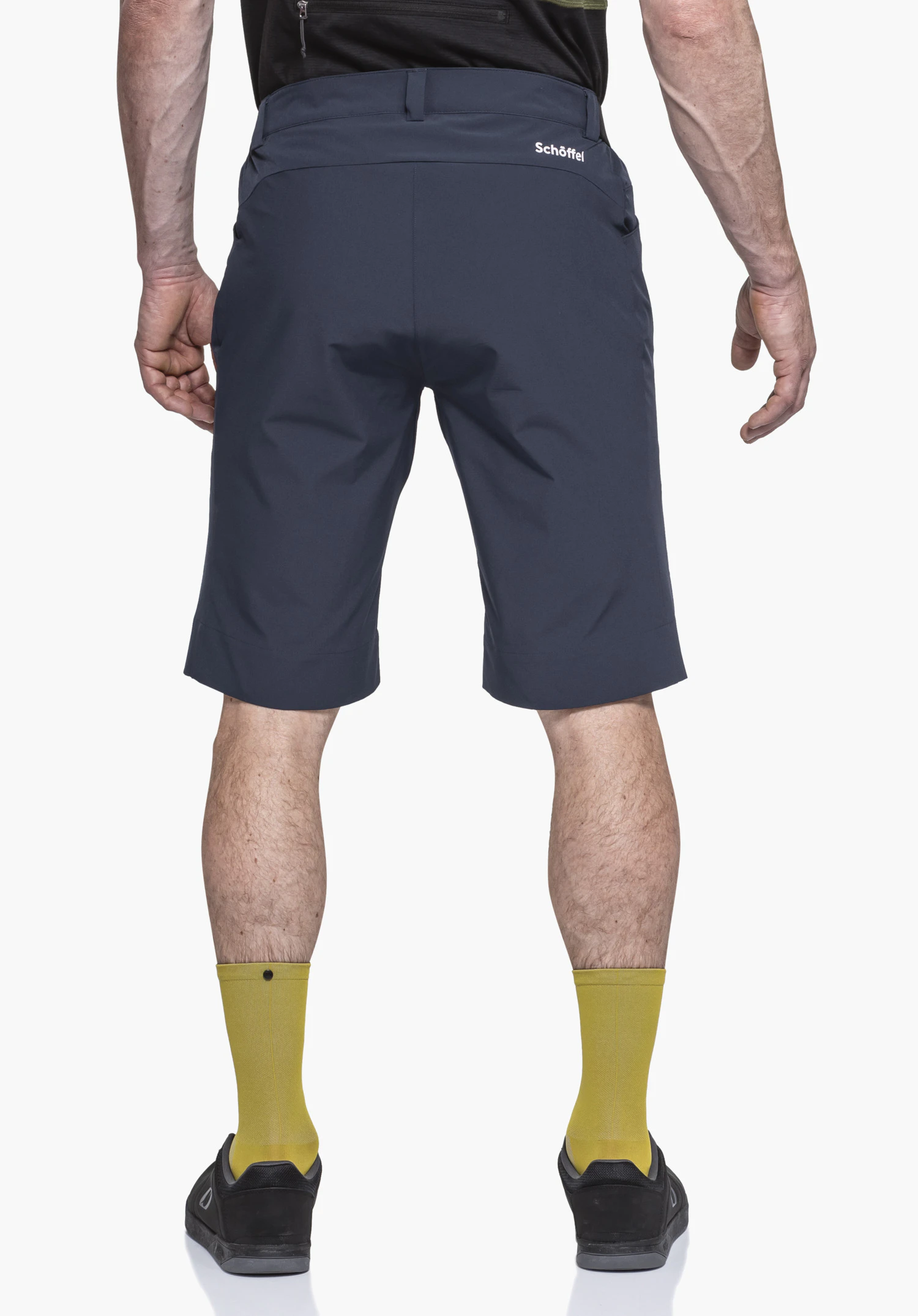 Shorts Style Keitele MNS in blue: The model is shown from the back against a neutral background. The athletic cut highlights the fit, while the white Schöffel logo on the rear serves as a subtle accent.