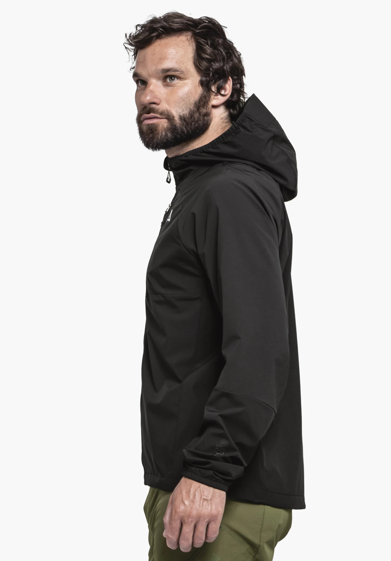 Hybrid Jk Style Mamry MNS in black. The male model stands in profile against a neutral background, showcasing the hooded jacket. The Schöffel logo is subtly visible on the sleeve cuff.