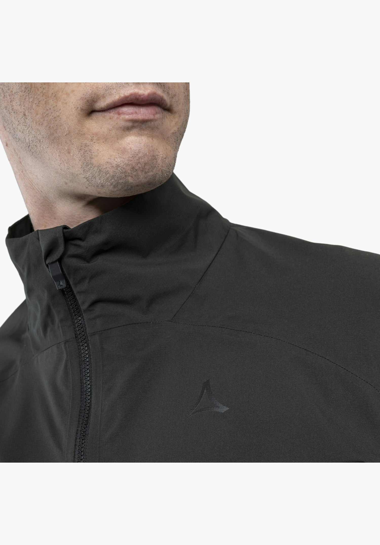 Jacket Style Lurbek MNS shows in detail the black collar, the zip, and the tonal Schöffel logo on the chest, close-up in front of a white/neutral background.