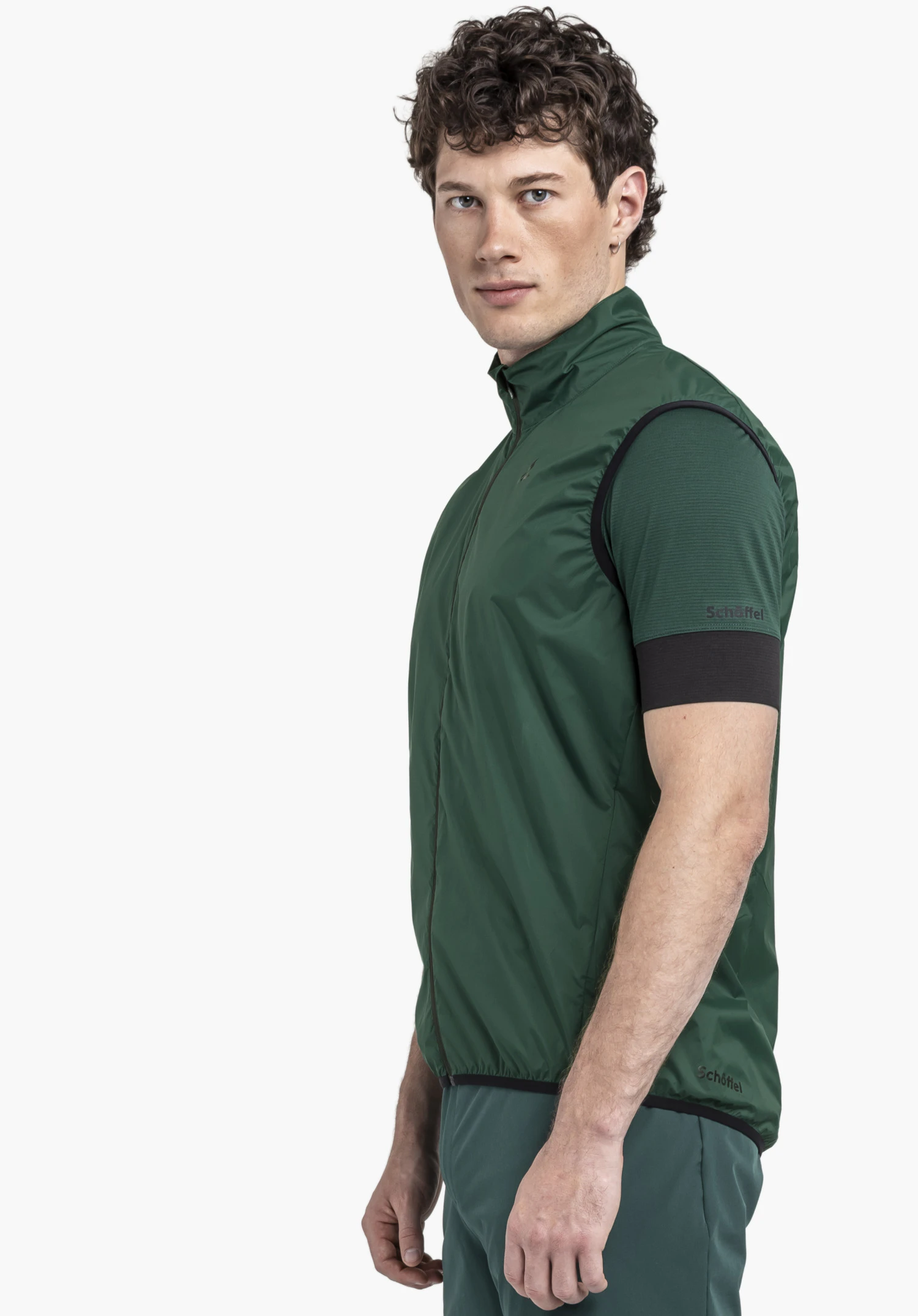 Vest Style Cannobio MNS features a model standing sideways in the green gilet against a neutral background, with the Schöffel logo subtly visible.