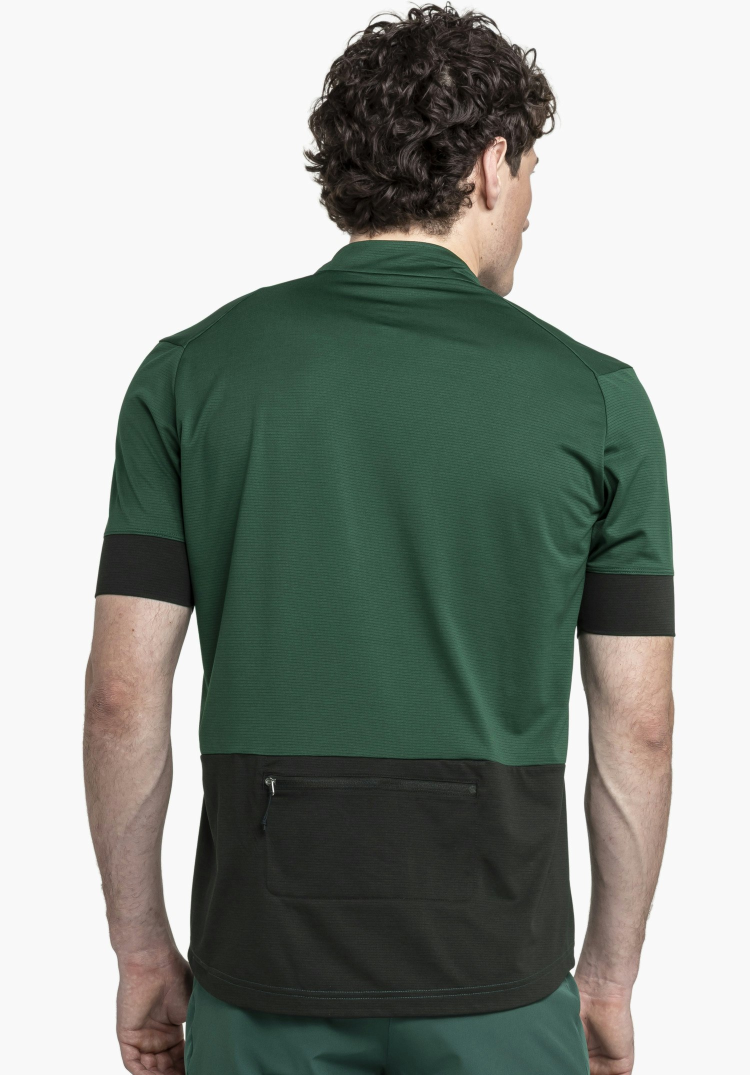 CIRC Shirt Style Pinega MNS shown from the back against a neutral background. The model wears the shirt in a rich green tone with contrasting dark details. The functional zipped back pocket is clearly visible.