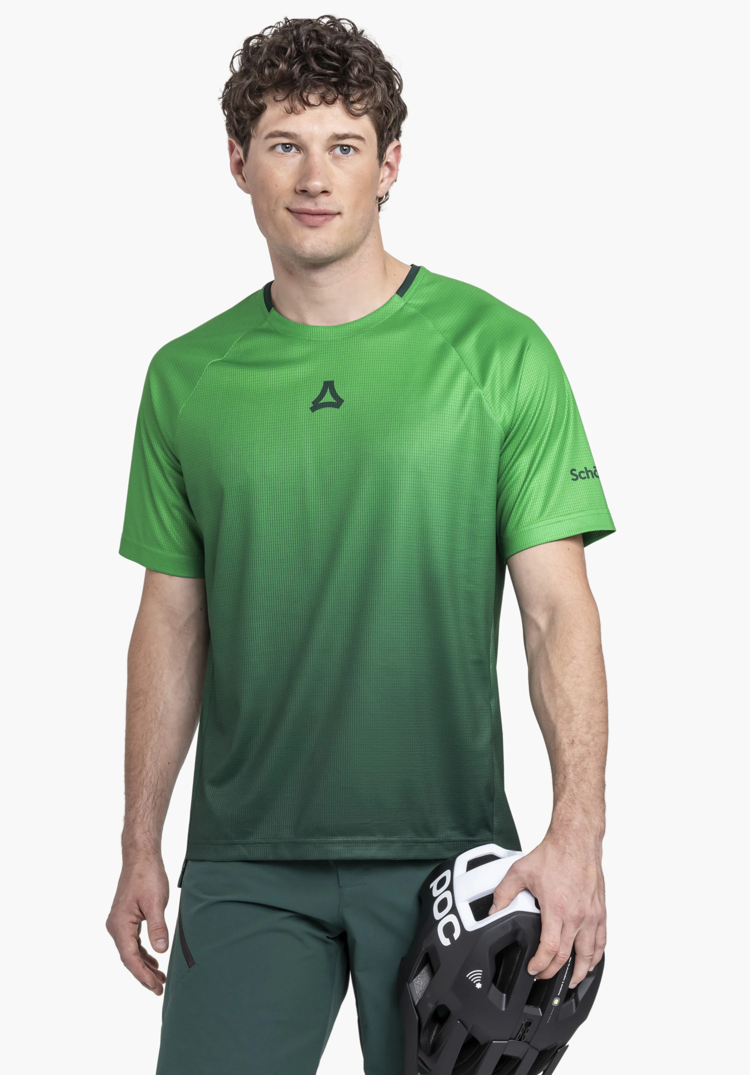 Shirt Style Koitere MEN in green: A model stands facing the camera against a neutral background, showcasing the shirt. The subtle Schöffel logo on the chest and sleeve completes the sporty look.