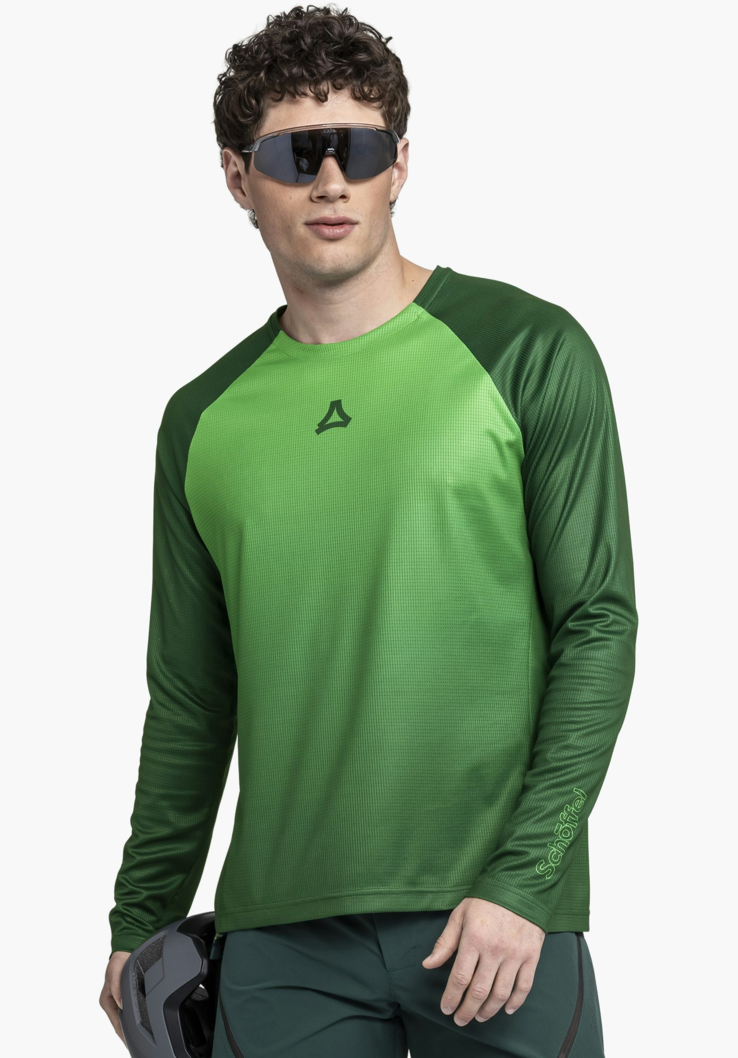 Longsleeve Style Koitere MEN shows the textured surface of the green fabric and the distinct Schöffel logo on the sleeve as a close-up against a white/neutral background.