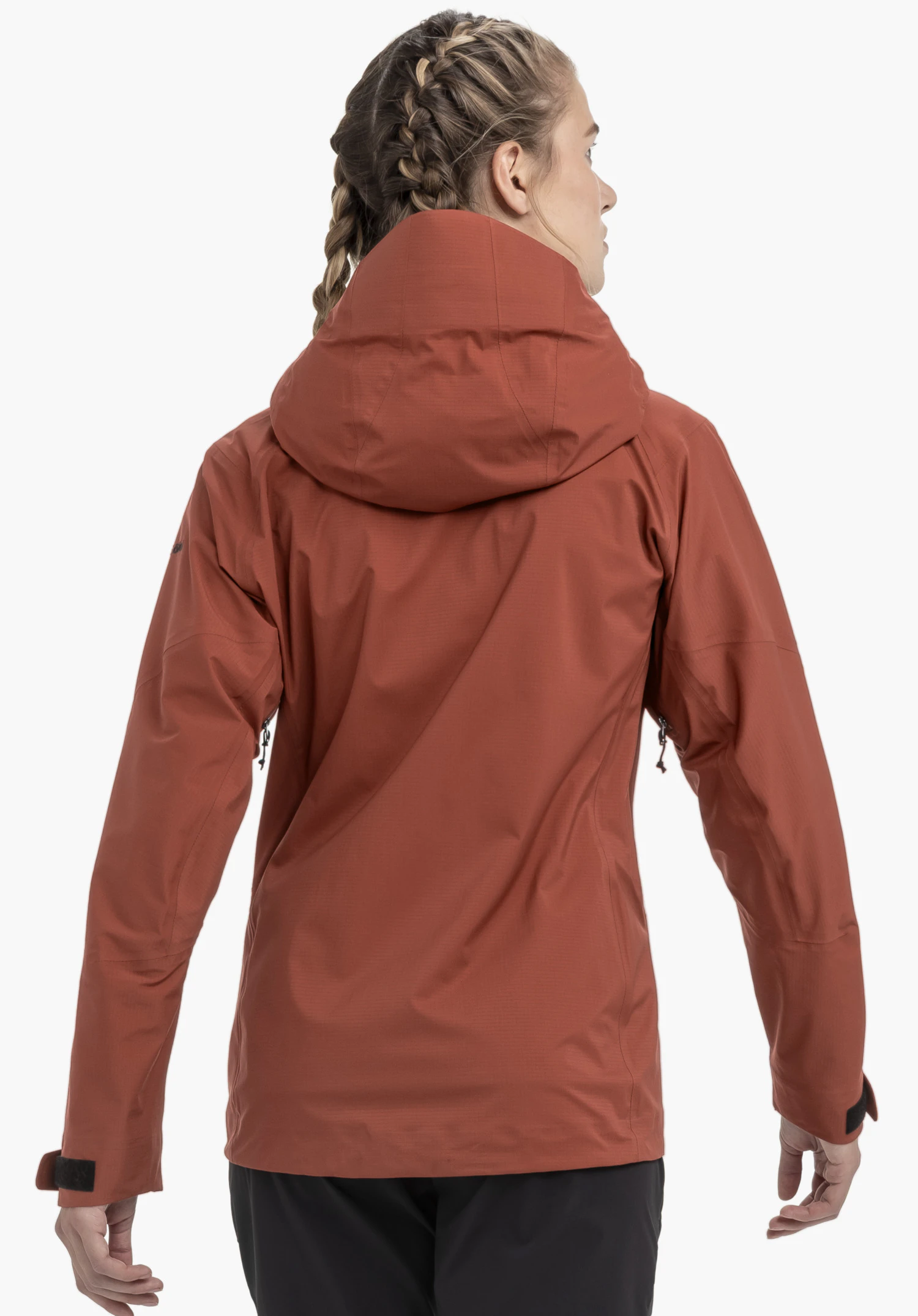 Jacket Style Blaueis WMS worn by a model in a back view. You can see the fit, the cut, and the large hood of the red jacket, with a small Schöffel logo visible on the side of the left sleeve, photographed against a neutral background.