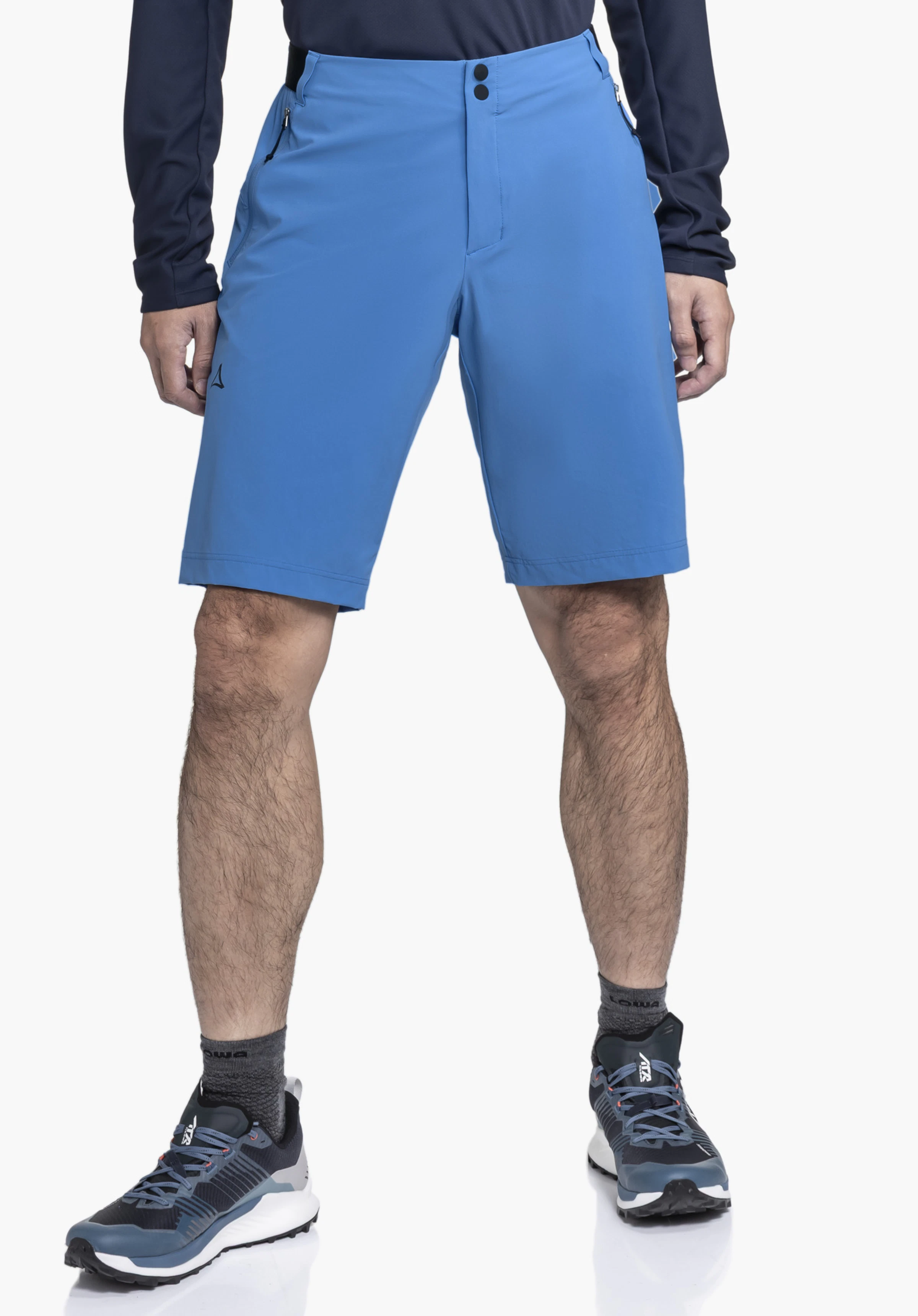 Shorts Style Blaustein MNS. A model stands facing forward wearing the blue shorts with a visible Schöffel logo on the right leg against a neutral background.