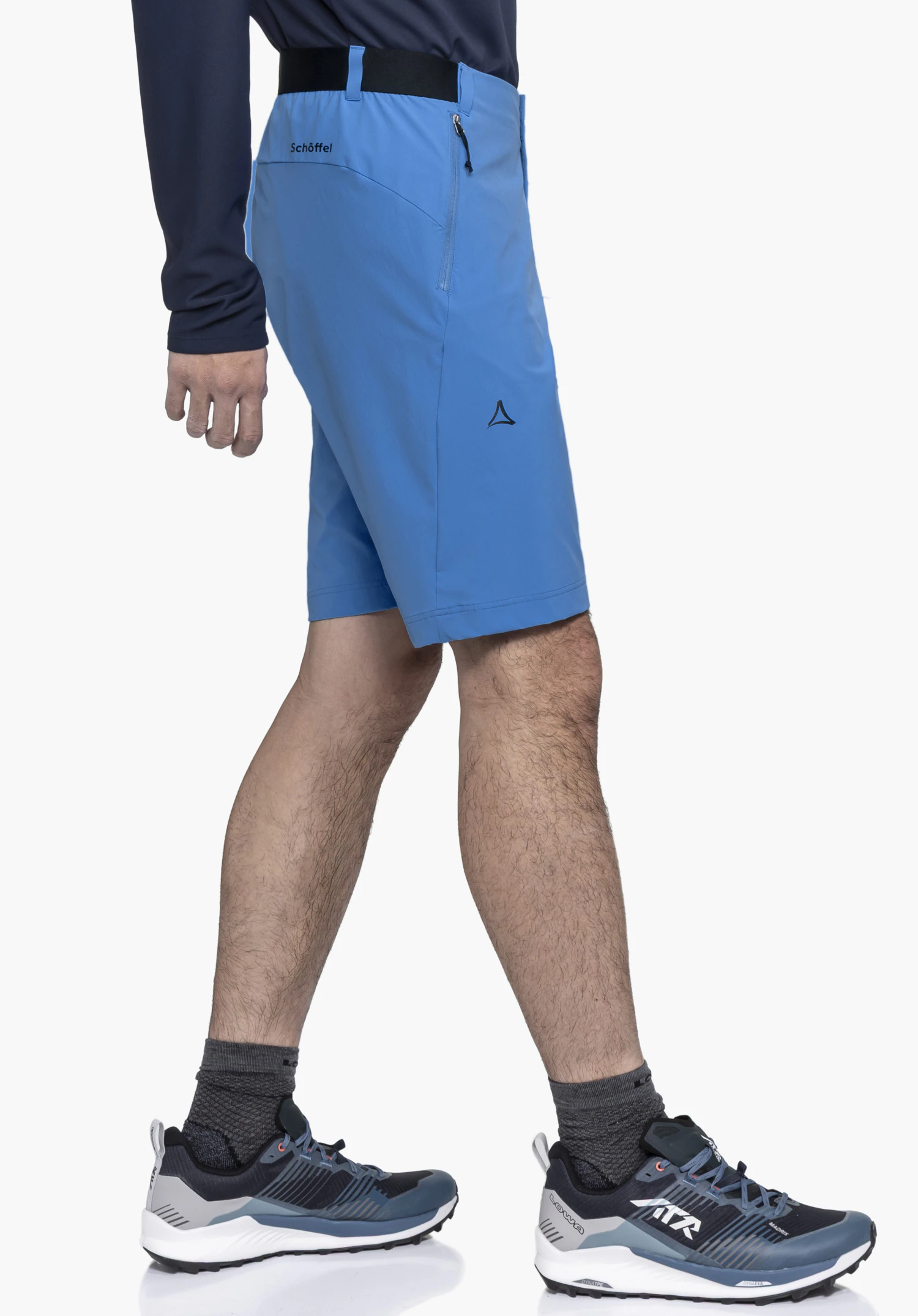 Shorts Style Blaustein MNS in blue, shown in a side view on a model against a neutral background. The subtle Schöffel logo on the thigh and the branding on the waistband highlight the premium design for athletic outdoor activities.