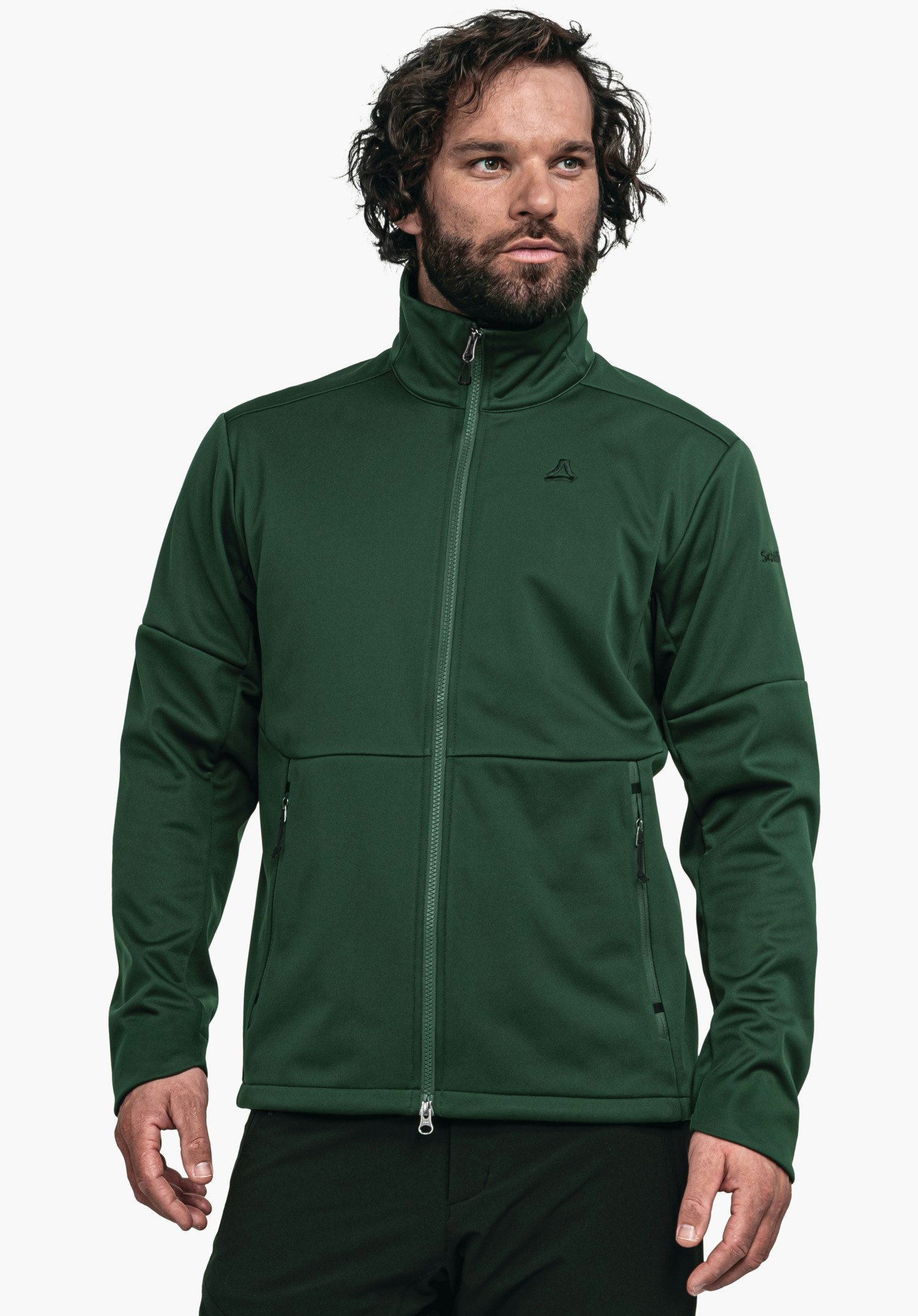 Softshell Jk Style Fracon MNS dunkelgrüne Jacke, getragen von einem stehenden Mann, der nach rechts blickt; Reißverschluss geschlossen; Schöffel-Logo auf Brust; Text auf Ärmel: "Schöffel"; neutraler weißer Hintergrund.