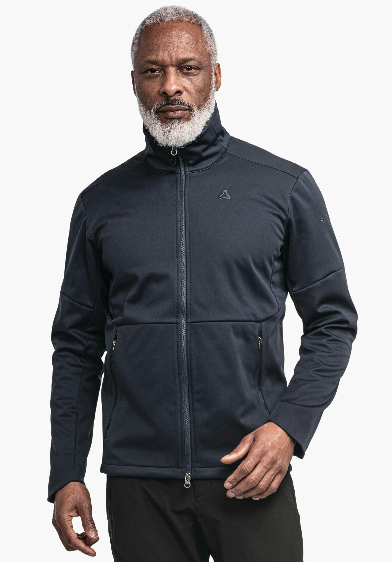 Softshell Jk Style Fracon MNS Dark blue softshell jacket worn by a man, zip closed, Schöffel logo on chest, hands visible, white background. Text: “Schöffel”.