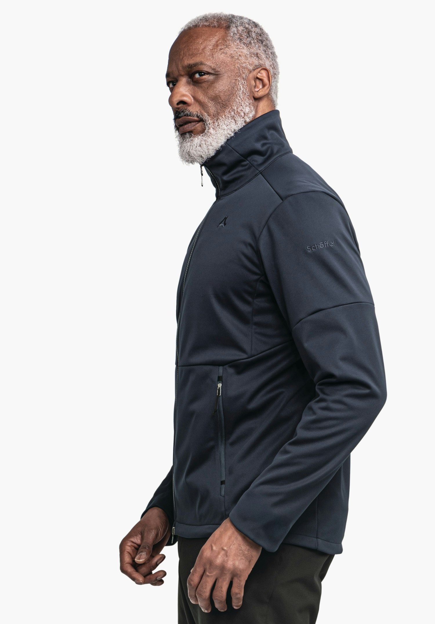 Softshell Jk Style Fracon MNS man wears a dark blue jacket with Schöffel logo, stands side-on and looks forward, light white background. Text in image: "Schöffel".