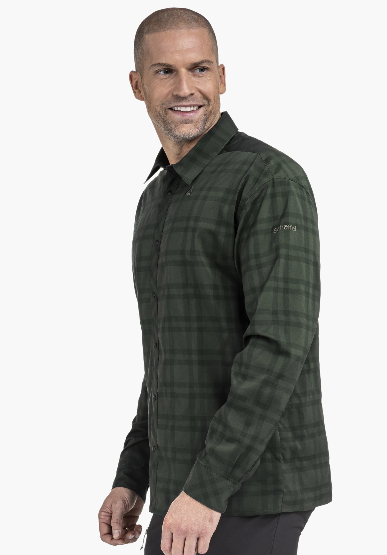 Shirt Style Yekuro MNS man wears a dark green checked shirt and looks side-on; Schöffel logo on the chest, lettering "schöffel" on the sleeve; open light background.