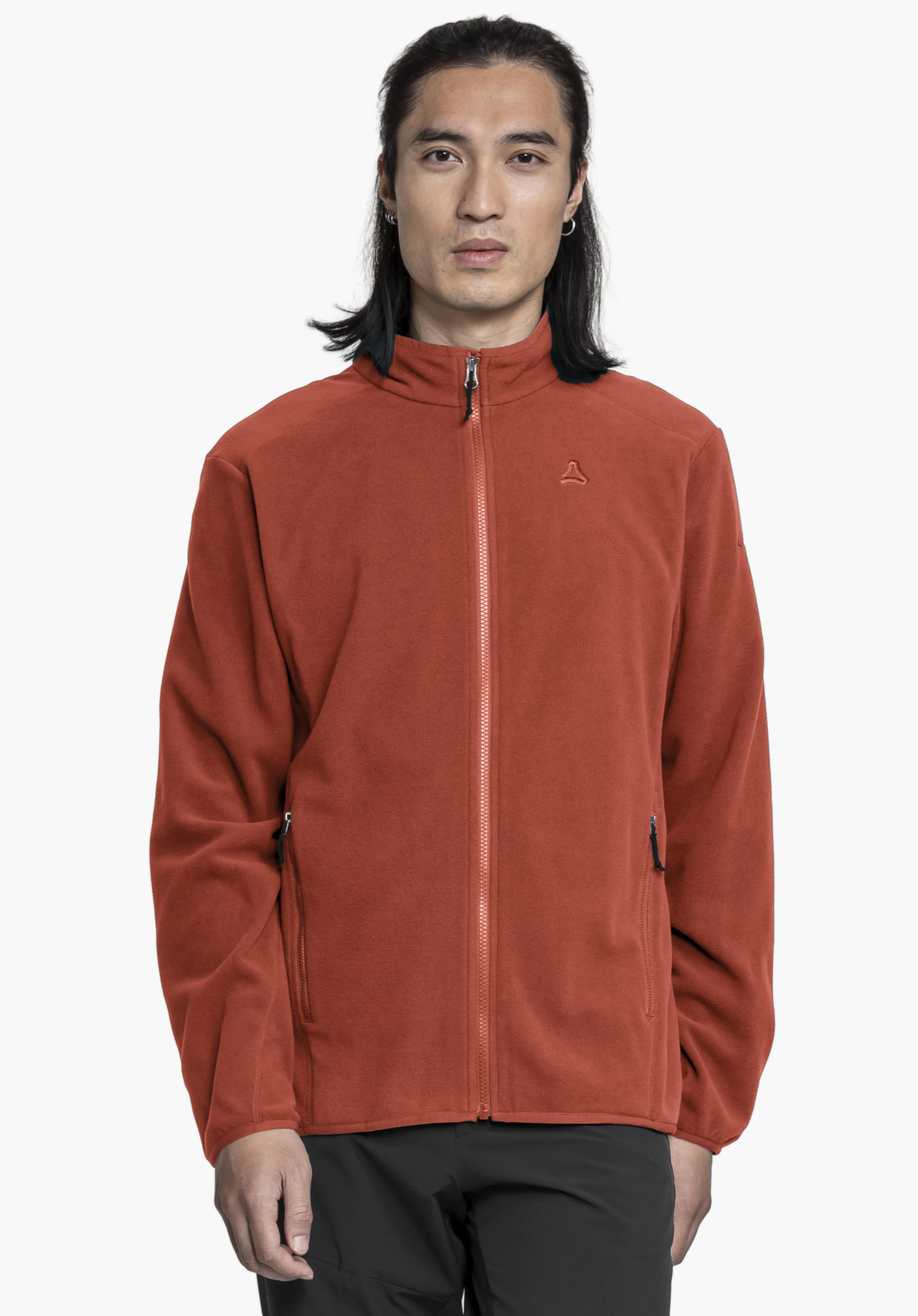 Fleece Jk Style Ash MNS worn by a model standing facing forward against a neutral background. The model is wearing the red fleece jacket fully zipped up. The Schöffel logo is visible on the left chest.