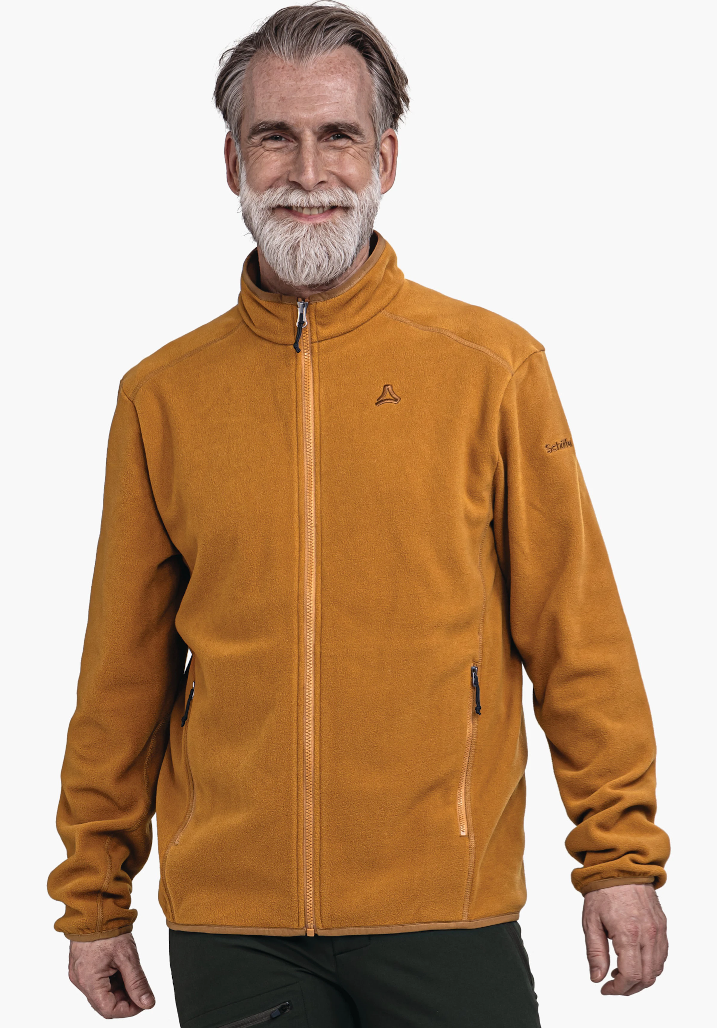 Fleece Jk Style Ash MNS veste polaire orange foncé, portée par un homme souriant; logo Schöffel sur la poitrine; texte sur la manche: «Schöffel»; pose debout devant un fond blanc.
