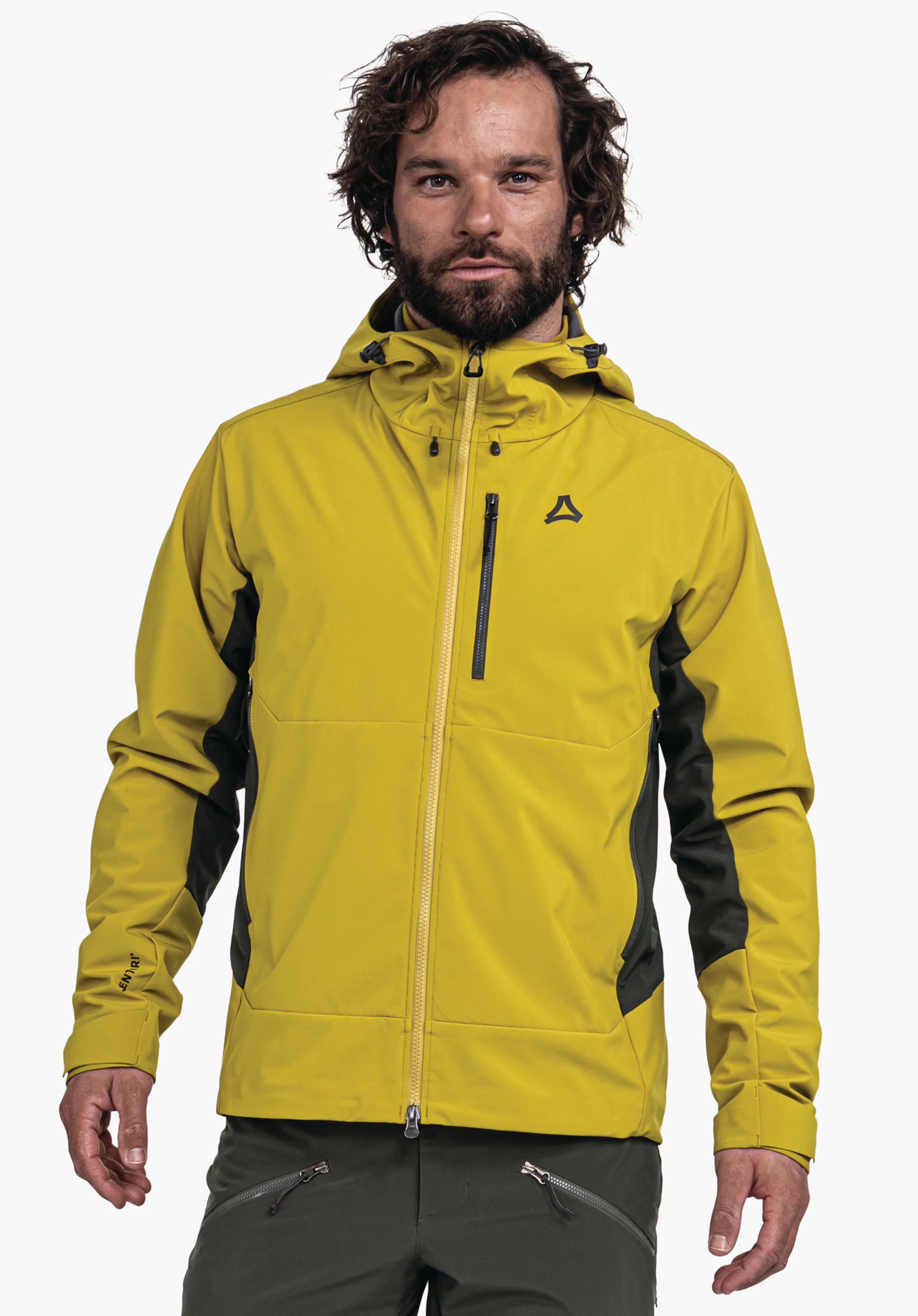 Softshell Jk Style Milagle MNS veste outdoor jaune, portée de face par un homme; fermeture éclair fermée, logo Schöffel sur la poitrine, empiècements latéraux vert foncé, fermetures éclair noires, fond blanc.