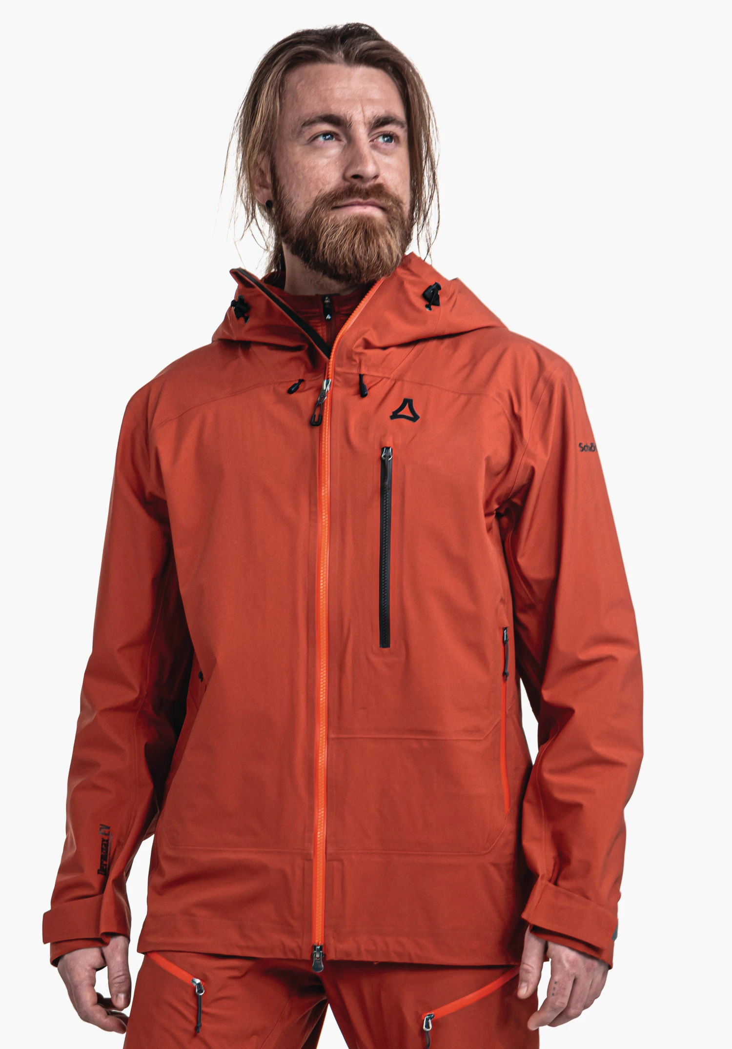 Jacket Style Milagle MNS rote Jacke, getragen von einem Mann, der nach oben rechts blickt; Schöffel-Logo auf der Brust; weißer Hintergrund; Text: "Schöffel" auf dem rechten Ärmel.