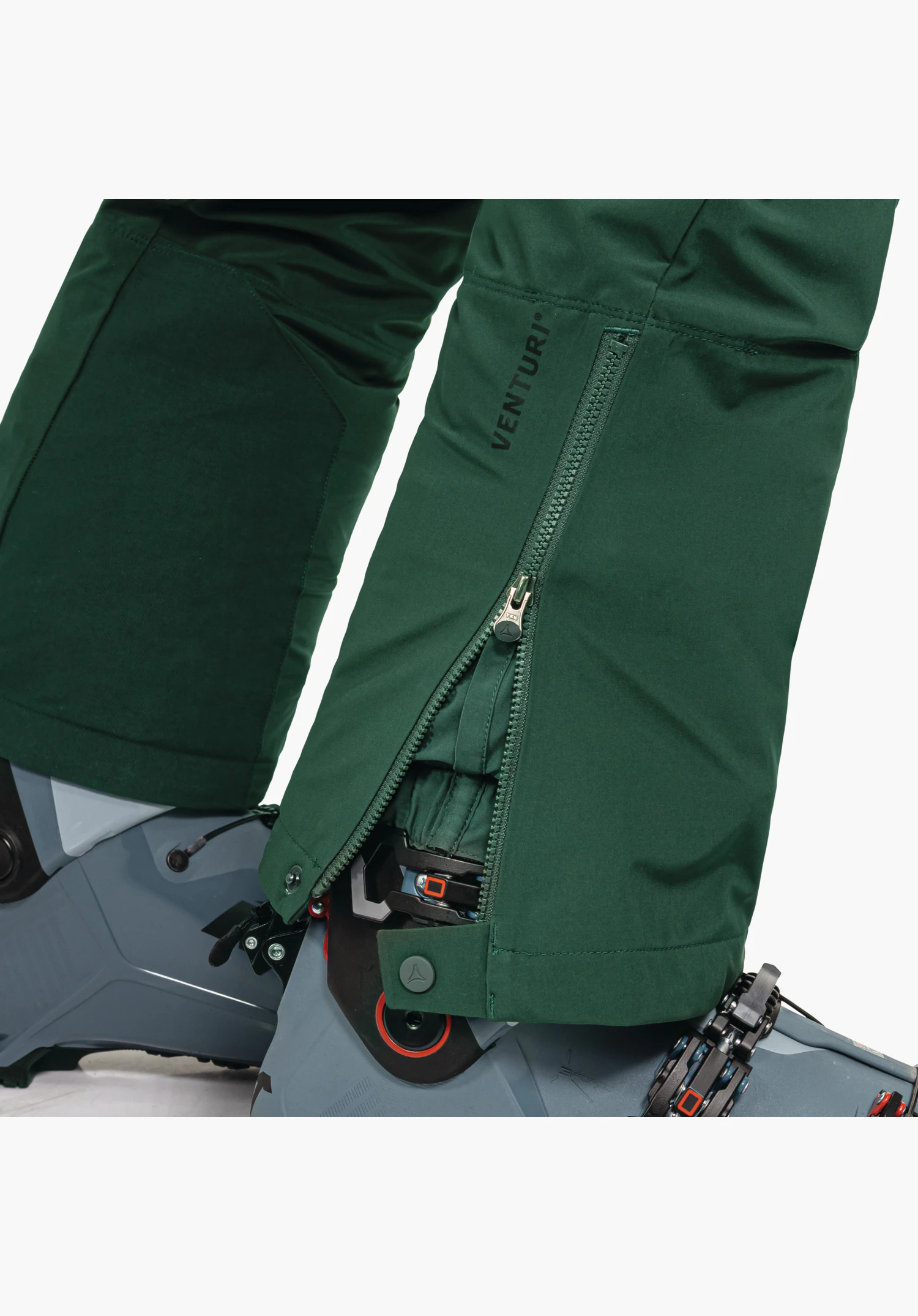 Softshell Pt Style Milagle MNS featuring the shoulder area with the embroidered Schöffel logo on the sleeve and the emblem on the chest on green fabric, close-up against a white background.