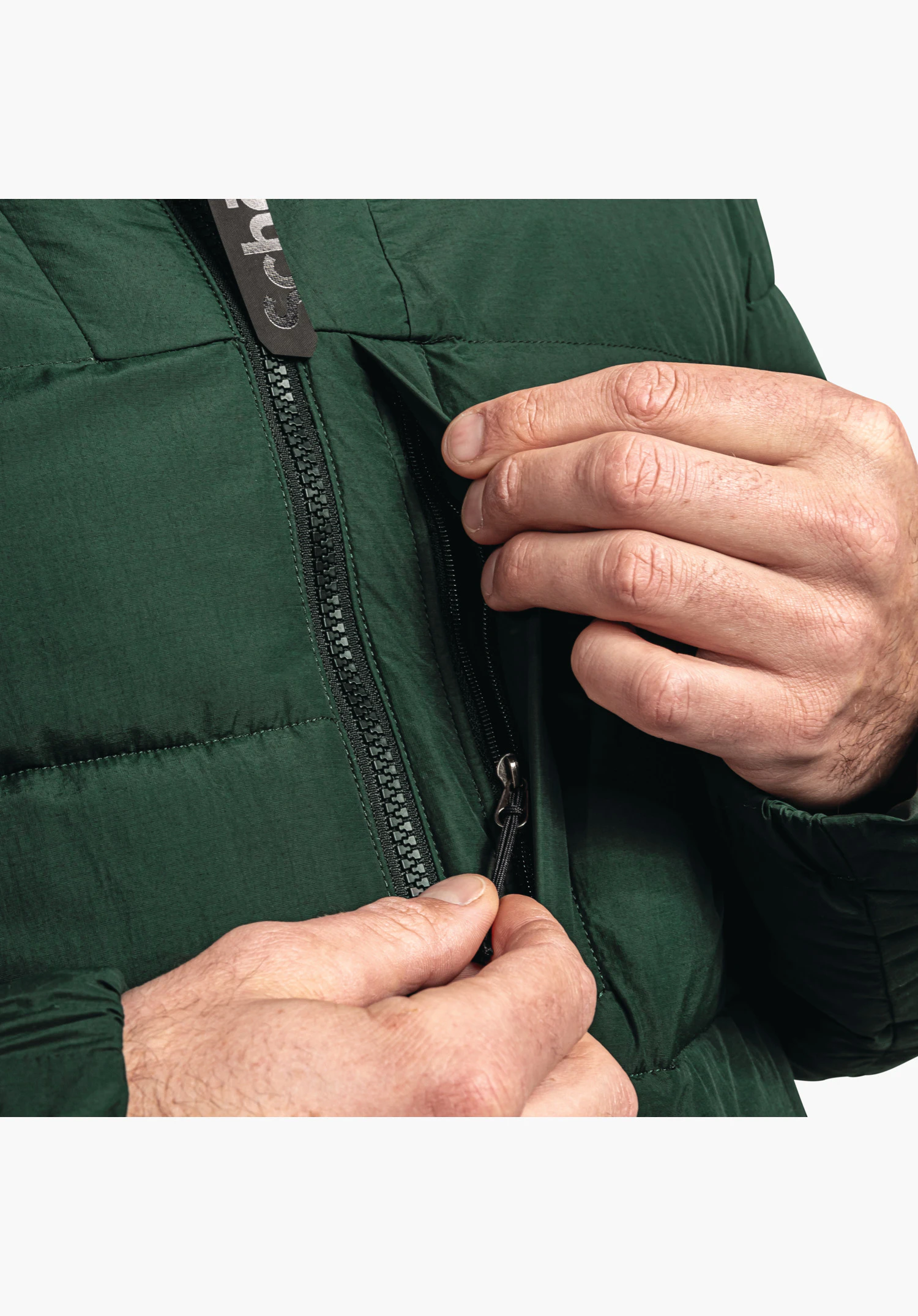 Ins Jacket Style Boslix MNS showing a detail of the vertical zipped chest pocket and the sturdy front zip set in green quilted fabric, close-up against a white/neutral background.