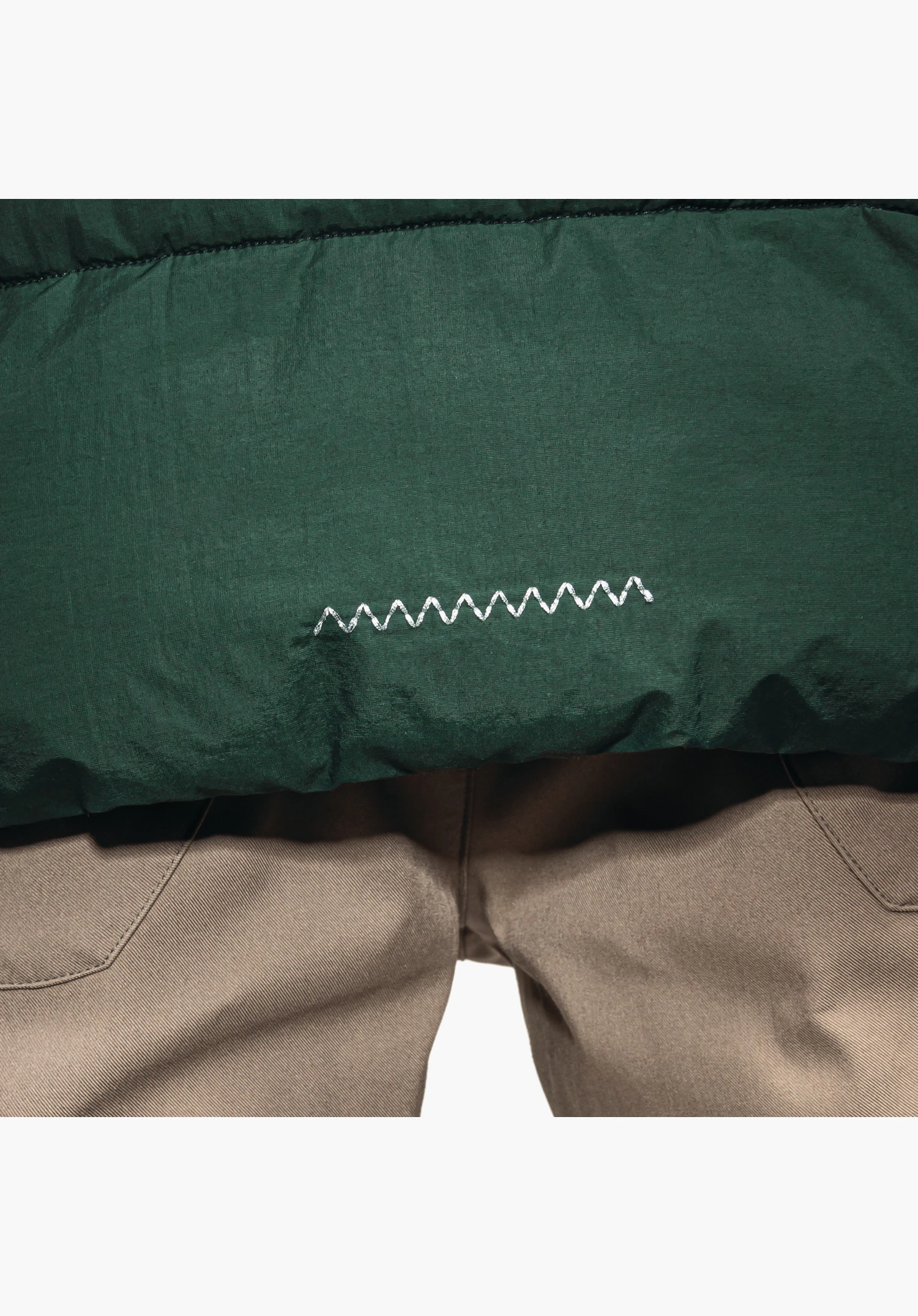 Ins Jacket Style Boslix MNS shows a decorative zig-zag stitching detail on the green fabric at the hem, close-up against a white/neutral background.
