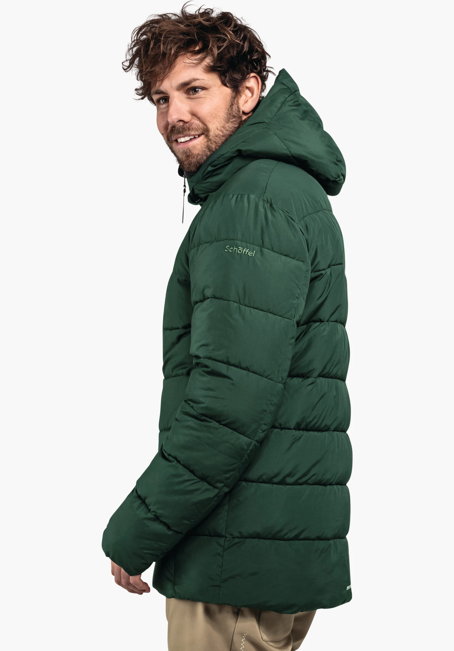 Ins Jacket Style Boslix MNS man wears a dark green quilted jacket with hood, smiles side-on and stands in front of a white background. Lettering: Schöffel.