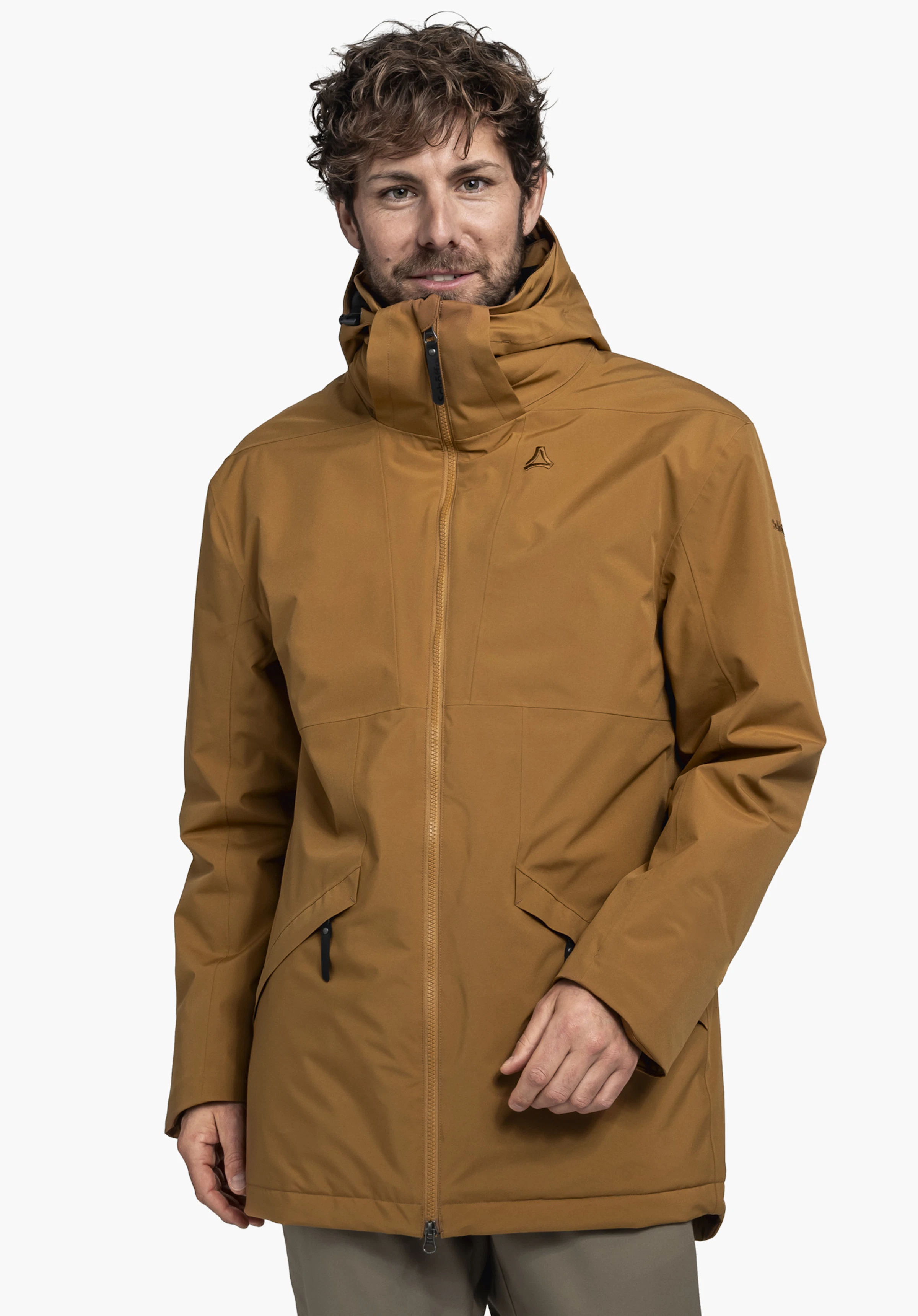 Ins Parka Style Malkay MNS Veste orange foncé portée par un homme debout de face, capuche entièrement fermée, logo Schöffel visible sur la poitrine, fond blanc.