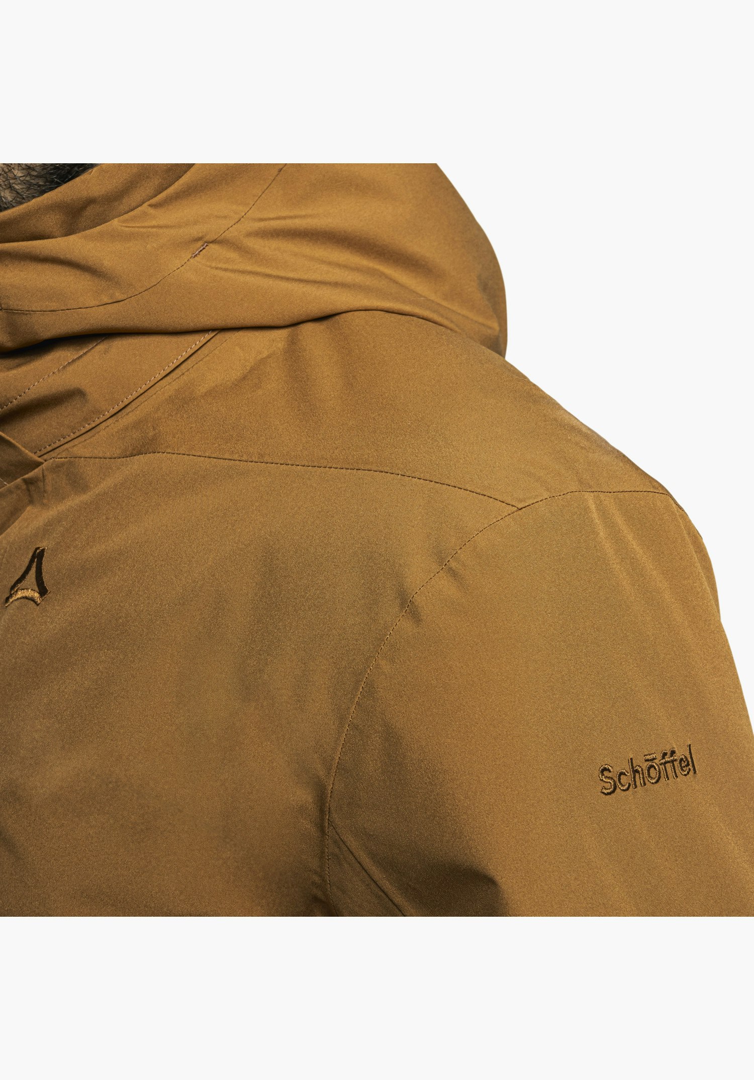 Ins Parka Style Malkay MNS zeigt ein Detail des Ärmels in Braun mit einer kleinen Reißverschlusstasche, aus der ein weißes Label mit dem Schriftzug „Ich bin raus.“ hervorsteht, Nahaufnahme vor weißem Hintergrund.