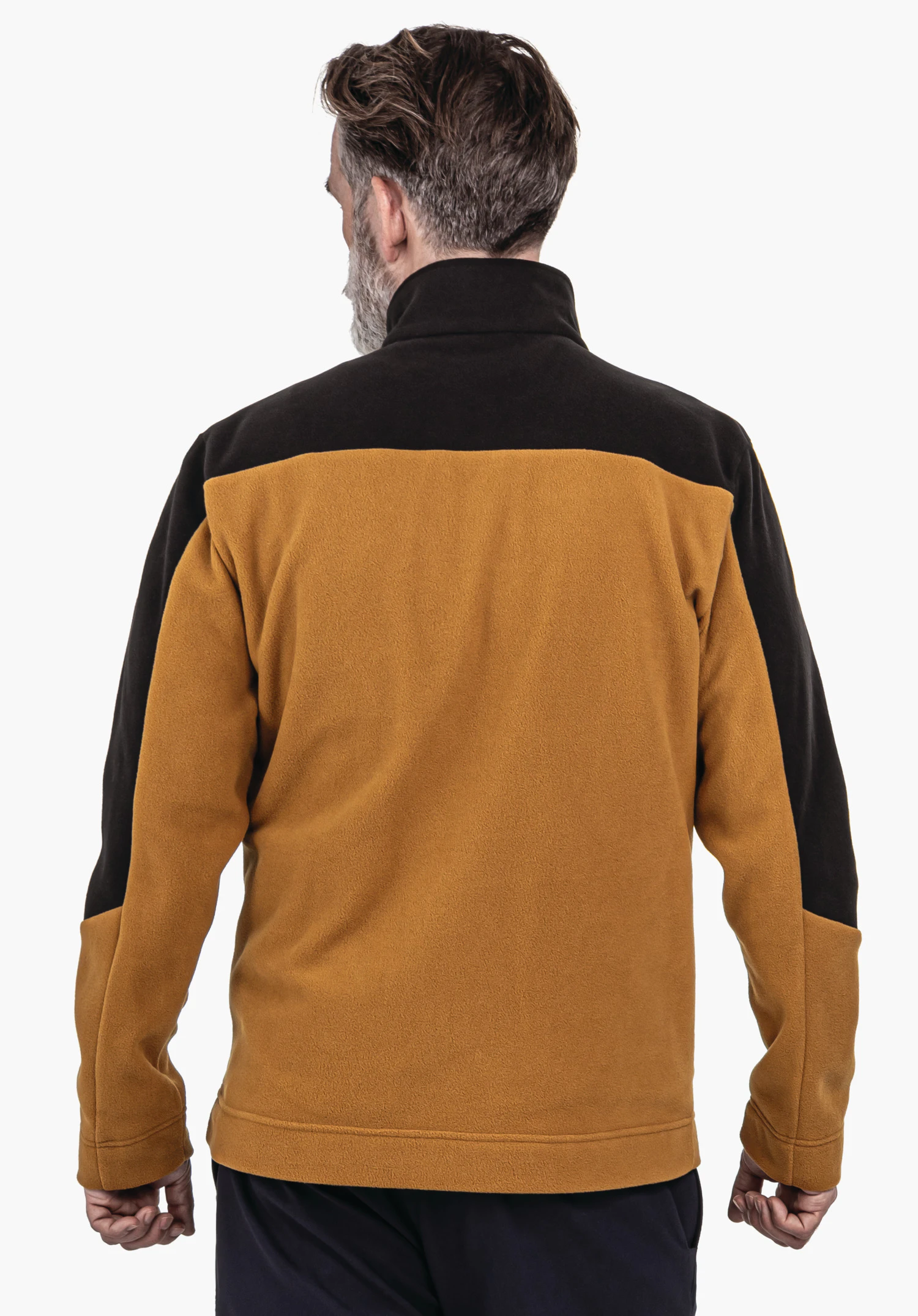 Fleece Jk Style Karif MNS veste jaune foncé avec empiècement noir, portée par un homme se tenant dos à la caméra devant un fond clair neutre.