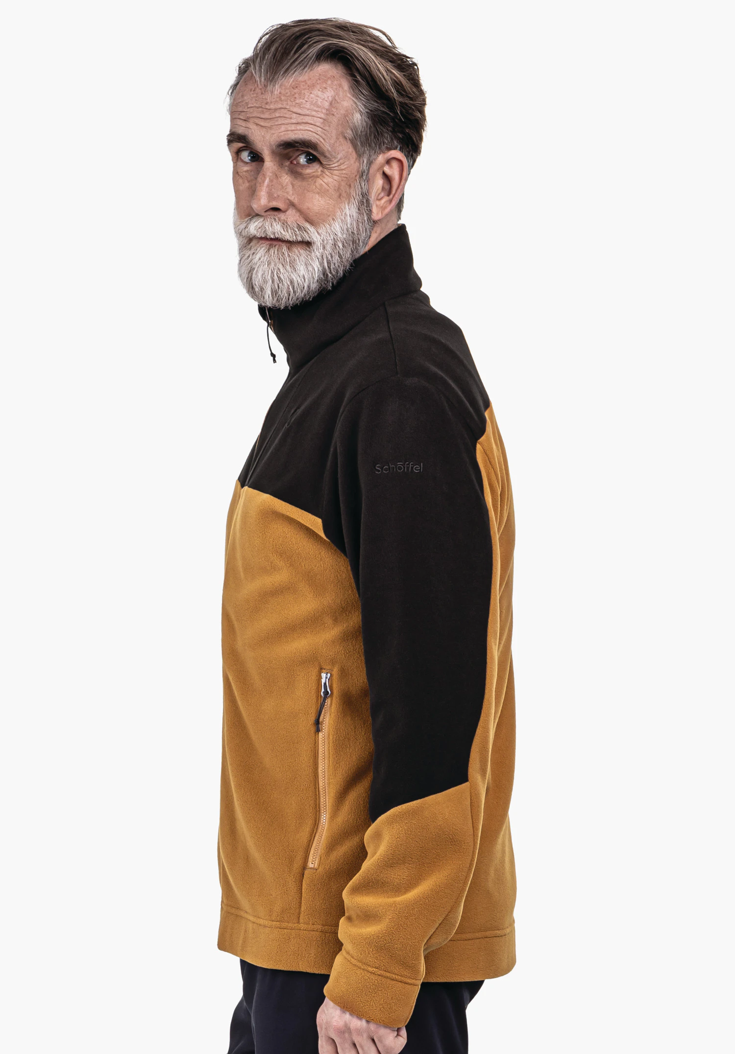 Fleece Jk Style Karif MNS veste polaire avec épaules noires et buste jaune foncé, portée par un homme âgé regardant de profil vers la caméra; fond blanc. Texte: "Schöffel".