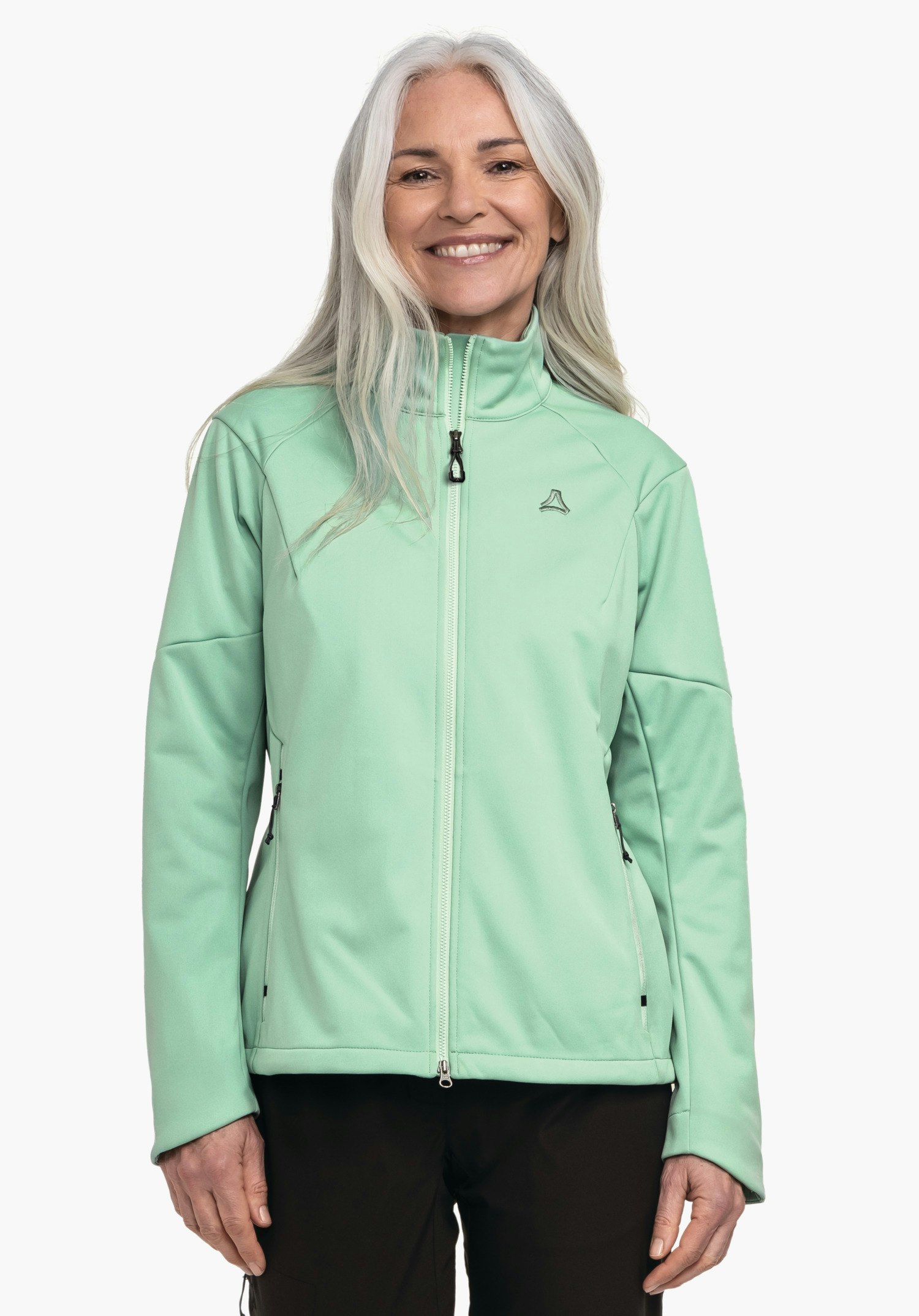Softshell Jk Style Fracon WMS Veste vert clair portée par une personne souriante debout devant un fond blanc; logo Schöffel sur la poitrine gauche, pantalon noir visible.