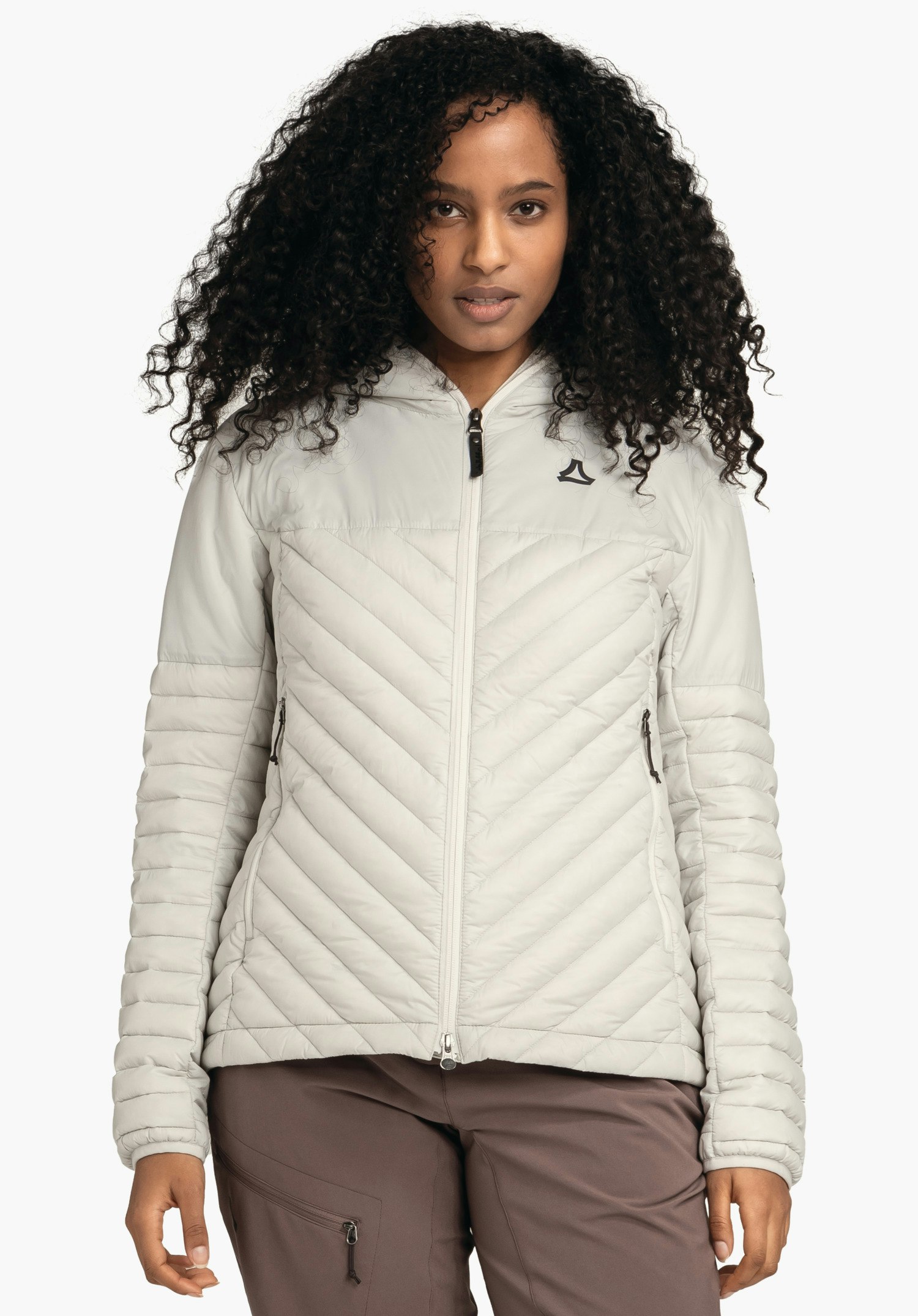 Down Jacket Style Cascata WMS light grey quilted jacket with zip and Schöffel logo, worn front-facing; person standing calmly with visible face; quilted pattern, side zip pockets, bright white studio background.