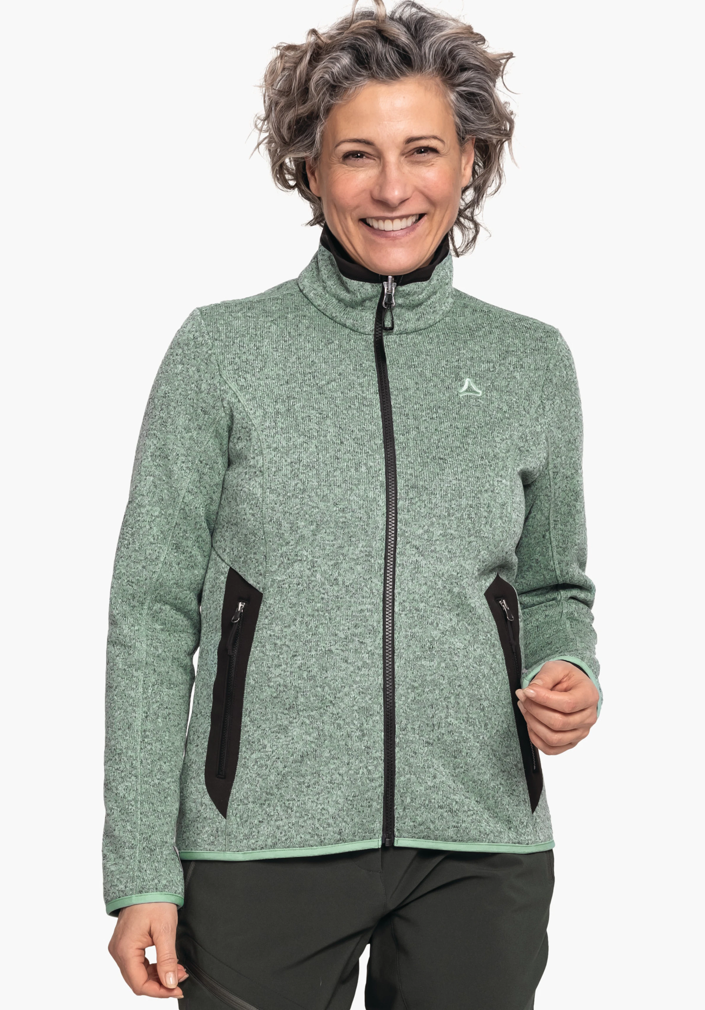 CIRC Fleece Jk Style Yew WMS light green jacket with black front zip and Schöffel logo on the chest; worn by a smiling person against a light background, paired with dark green trousers.
