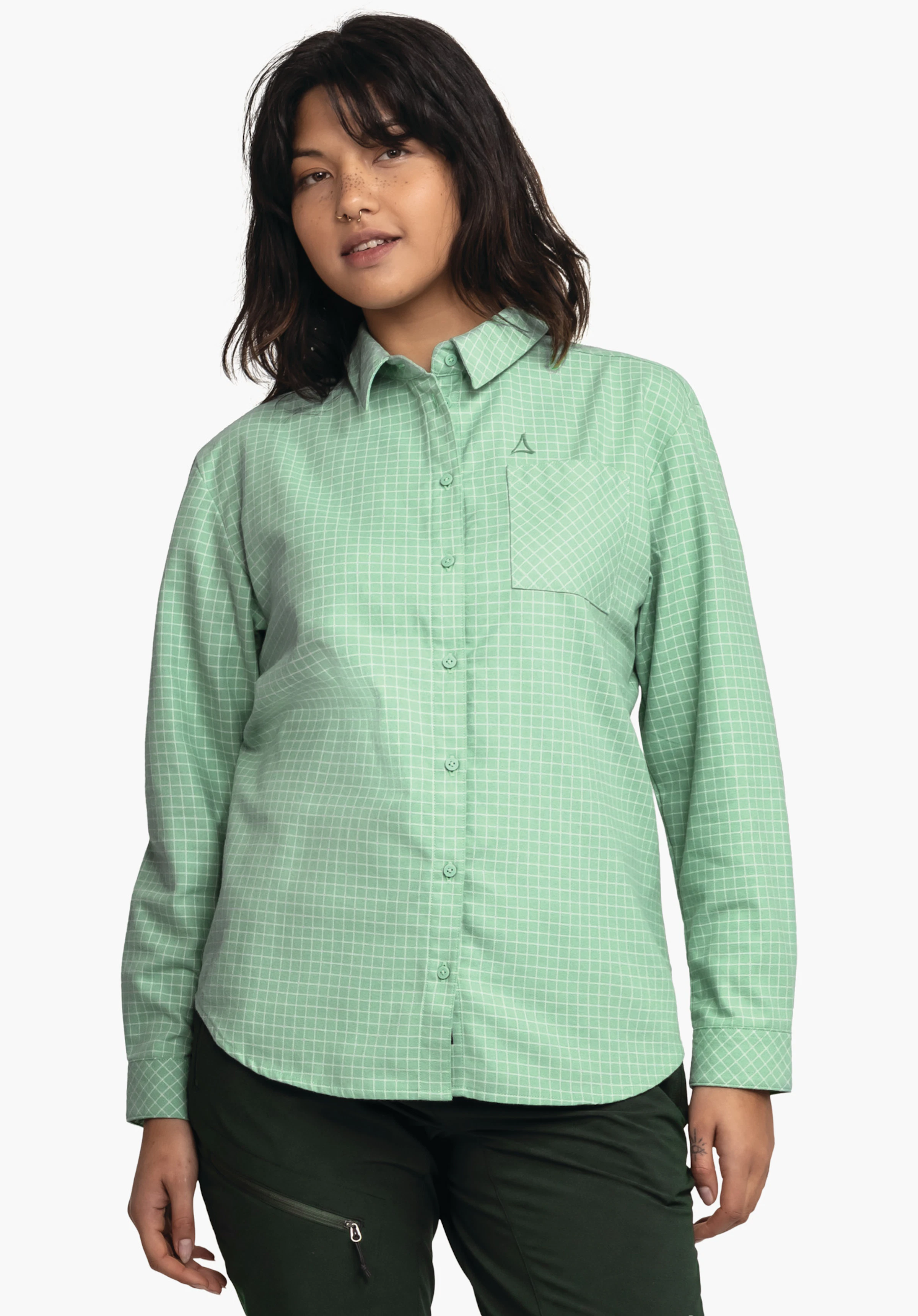 Blouse Style Boyoma WMS light green and white checked long-sleeve shirt worn by a woman; with chest pocket and Schöffel logo, paired with dark green trousers; light background.