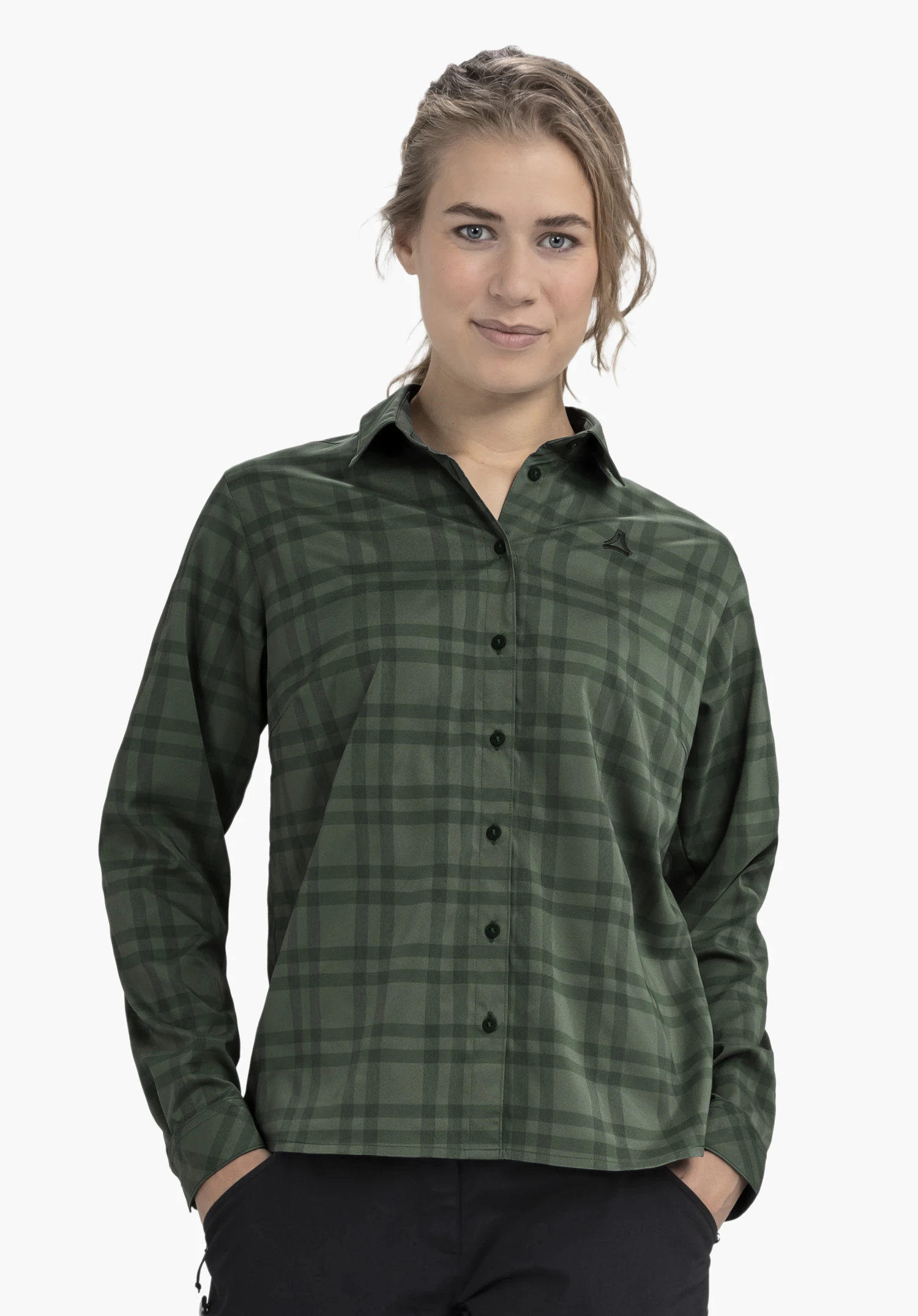 Blouse Style Yekuro WMS dark green checked blouse, buttoned at the front; worn by a person with black triangular Schöffel logo on the left chest; standing against a white background with hands in pockets.