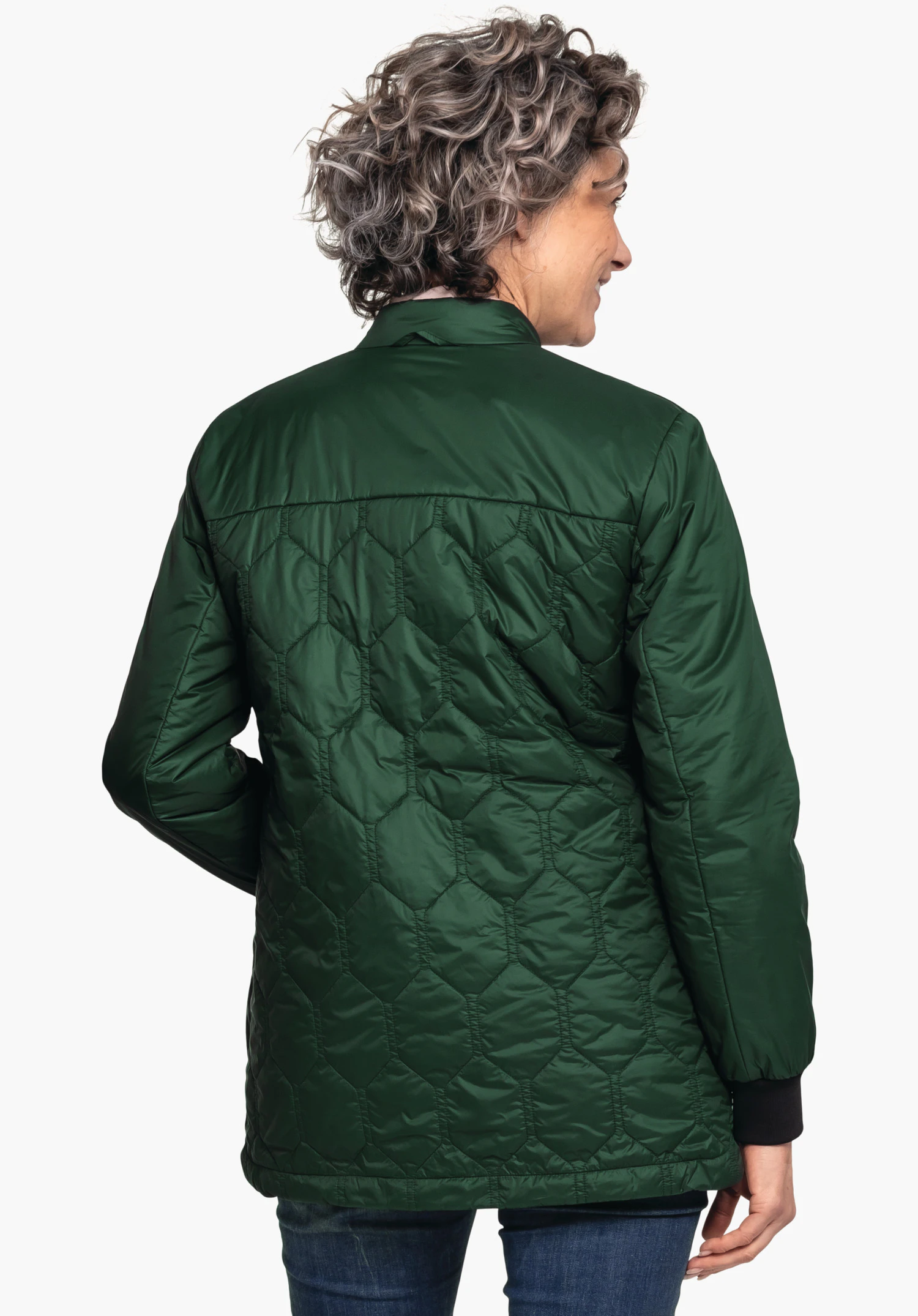 Ins Jacket Style Malkay WMS veste matelassée vert foncé, portée de dos par une personne; manches avec poignets noirs, jean bleu foncé; fond clair neutre.