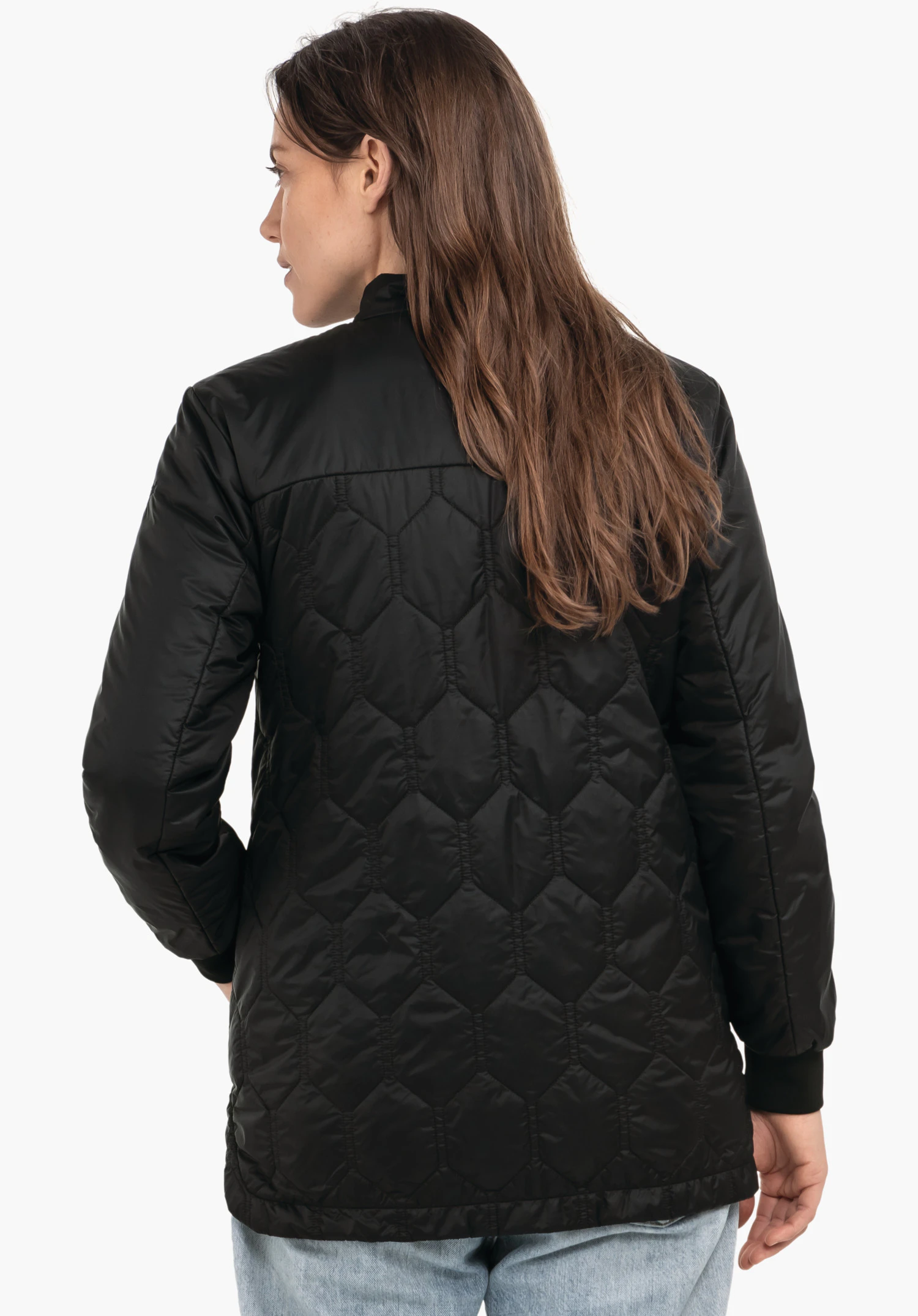 Ins Jacket Style Malkay WMS black quilted jacket worn from the back; head turned left, long hair, light blue jeans; white background.