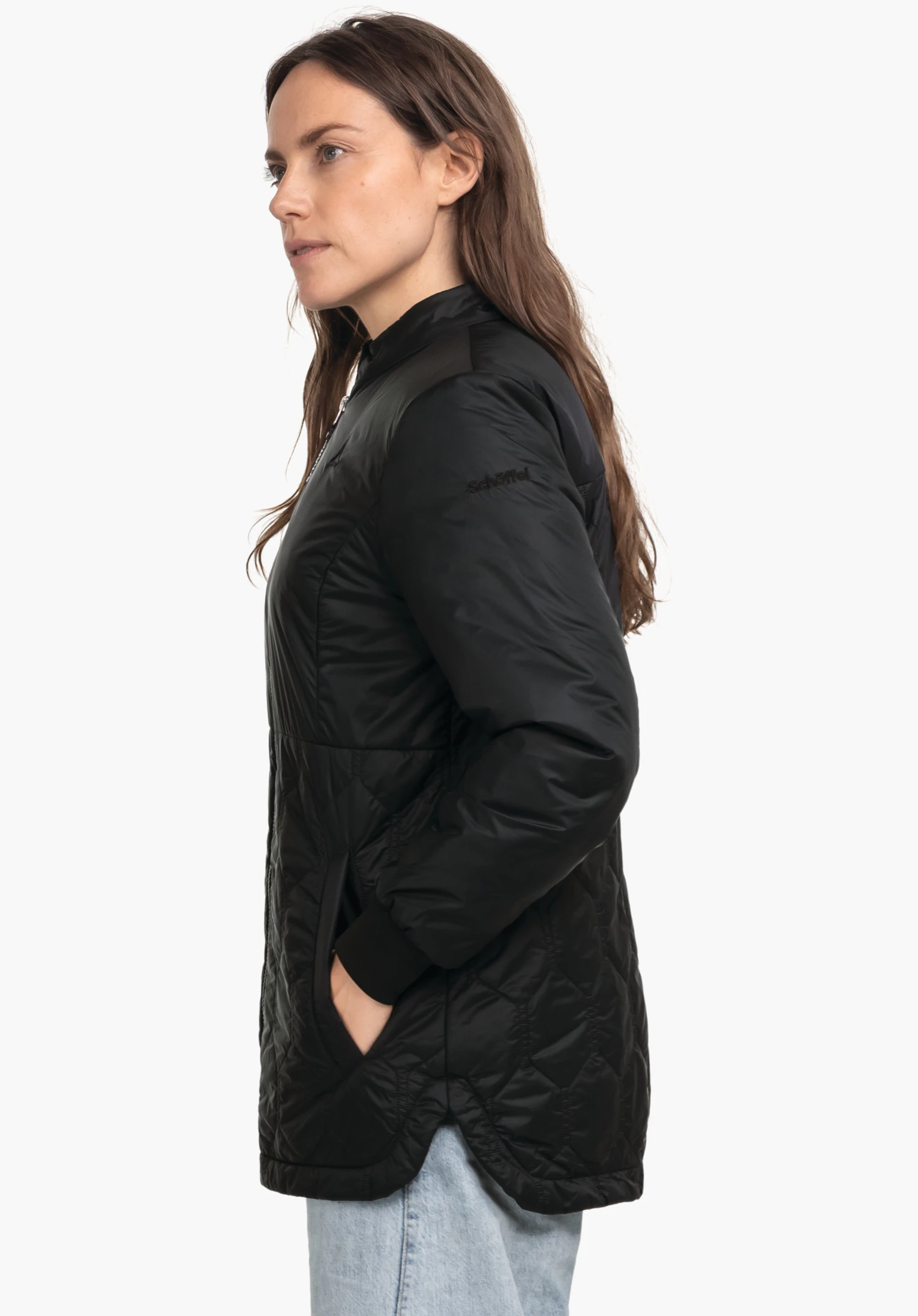 Ins Jacket Style Malkay WMS black quilted jacket, worn by a person standing side-on with one hand in the pocket; context: white studio background, light blue jeans. Sleeve lettering: "schöffel".