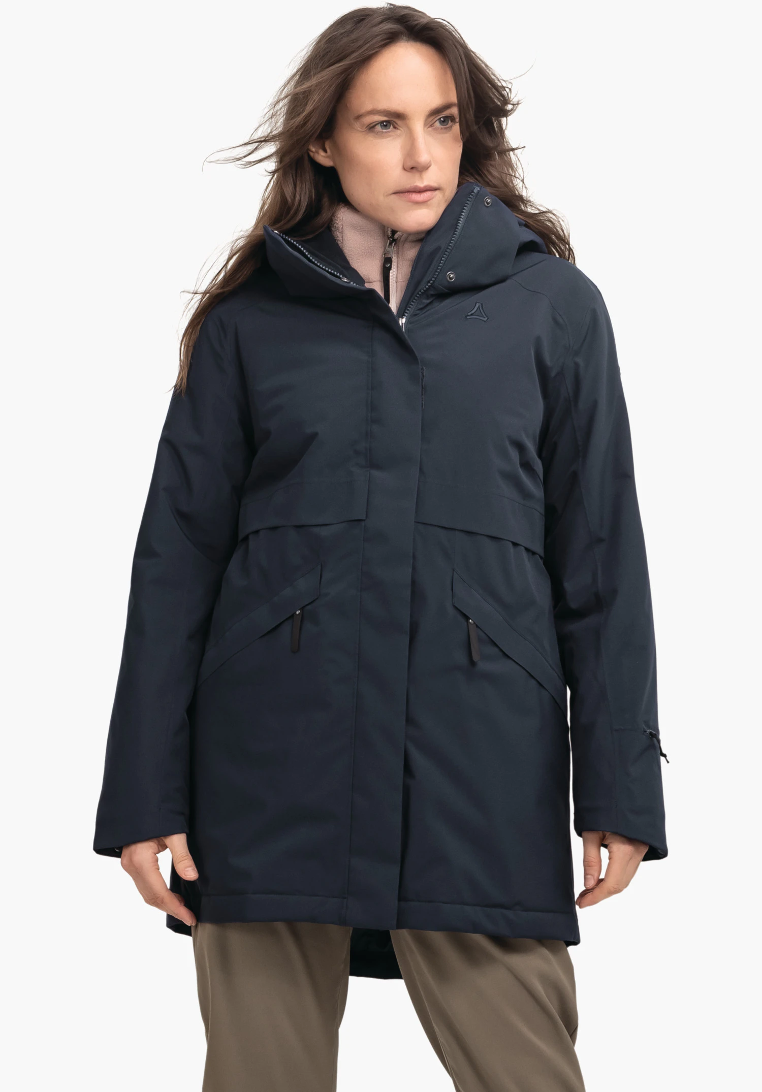 Ins Parka Style Malkay WMS dark blue parka with Schöffel logo, worn by a woman looking sideways; hood up, zip partially closed; neutral white background.