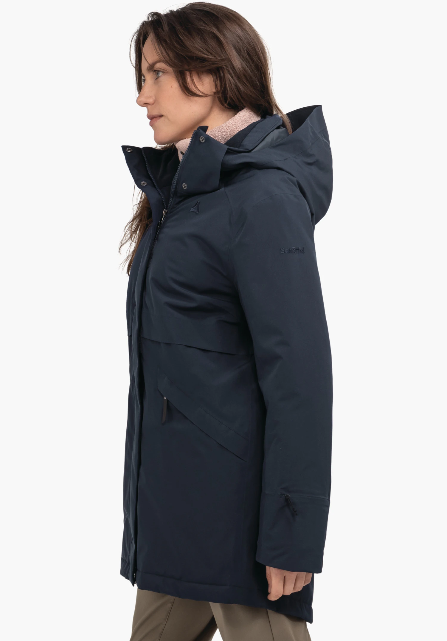 Ins Parka Style Malkay WMS dark blue parka worn by a woman standing side-on, hood raised, hand relaxed; context: white background. Schöffel logo visible. Text: "Schöffel".