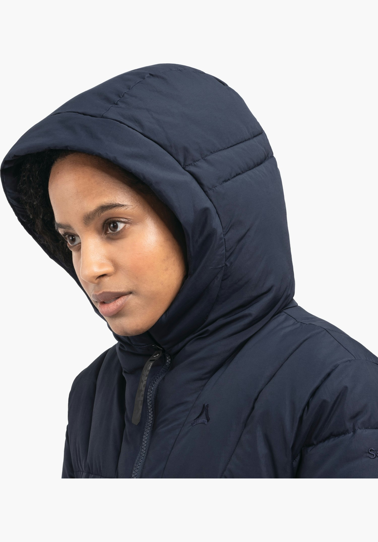 Ins Parka Style Boslix WMS features the padded hood, the high collar and the subtle Schöffel logo on the blue chest area, close-up shot against a white background.